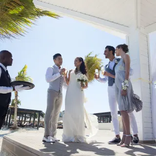 A wedding party toasting with champagne at Royalton Blue Waters, Montego Bay