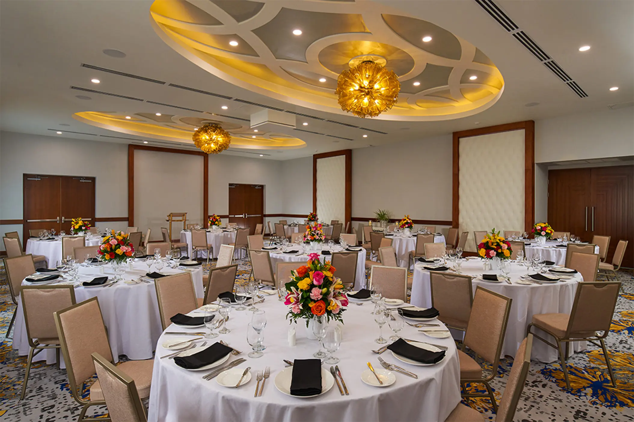 Ballroom wedding reception setup with floral centerpieces at Sandals Montego Bay, Montego Bay