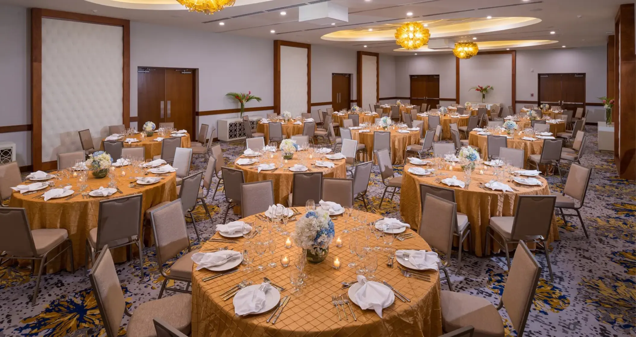 Ballroom wedding reception setup with gold linens at Sandals Montego Bay, Montego Bay