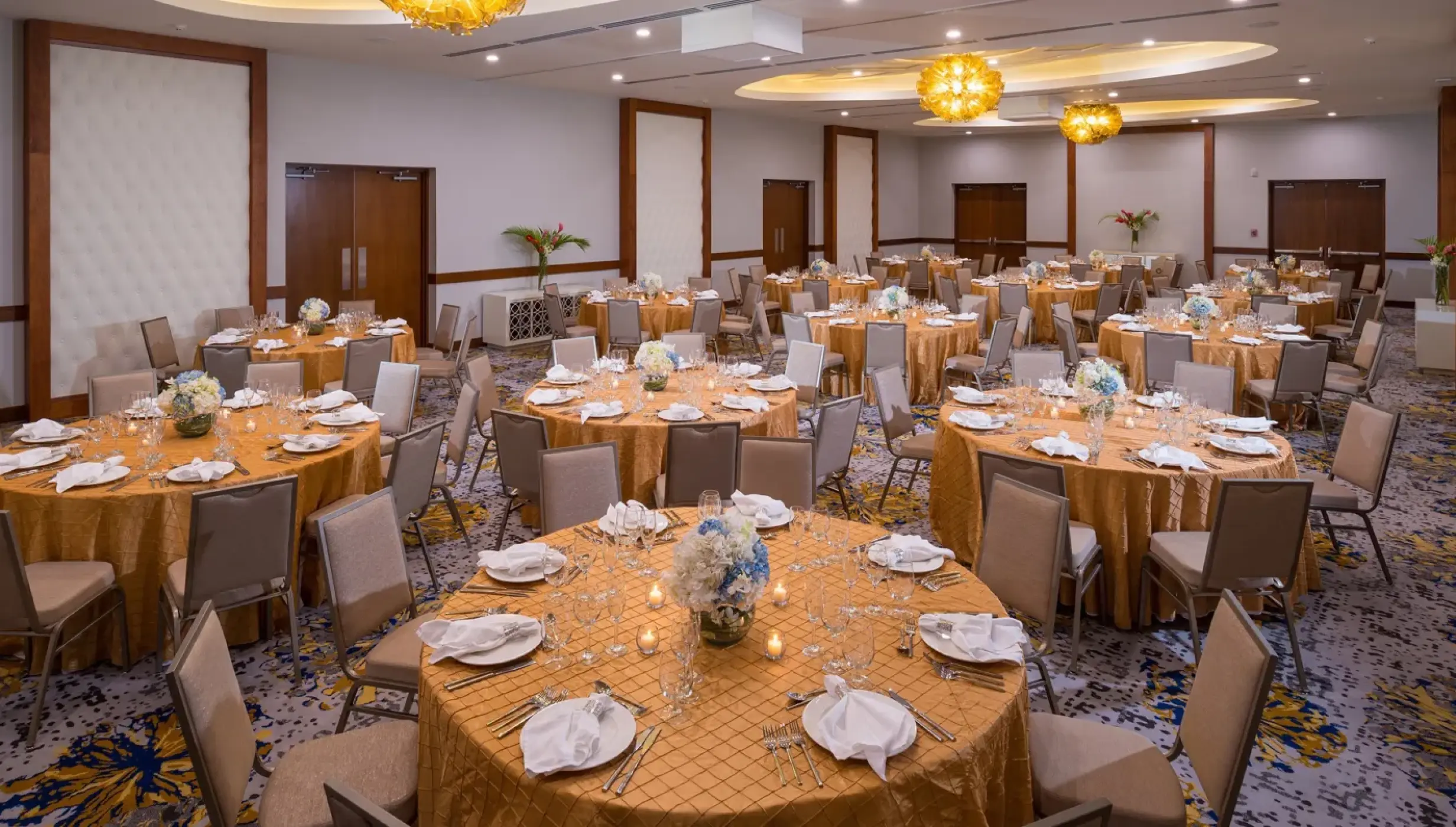 Ballroom wedding reception setup with gold linens at Sandals Montego Bay, Montego Bay