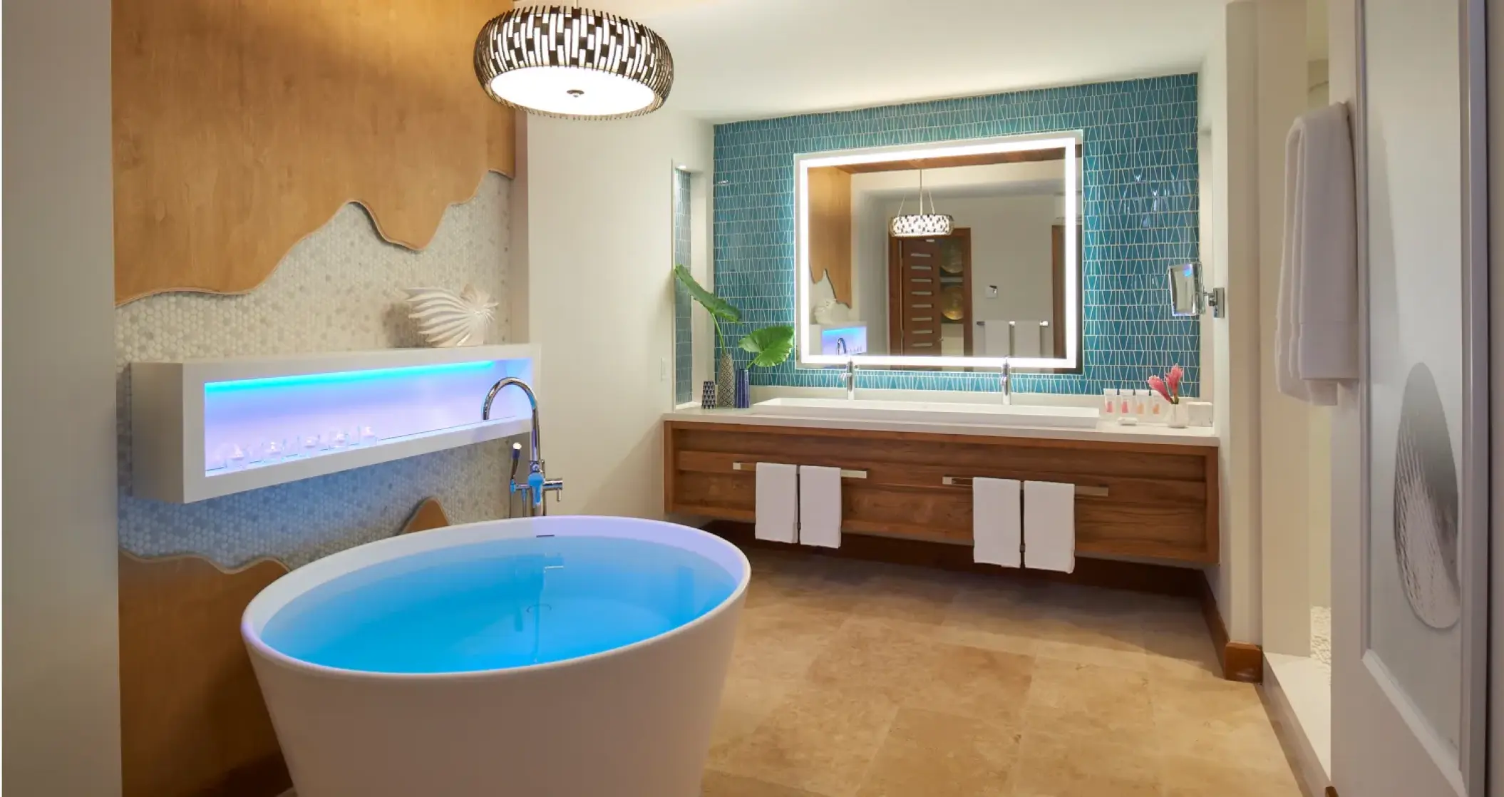 Modern suite bathroom with a freestanding tub and double vanity at Sandals Montego Bay