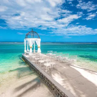 Overwater wedding ceremony gazebo and white chairs at Sandals Montego Bay, Montego Bay