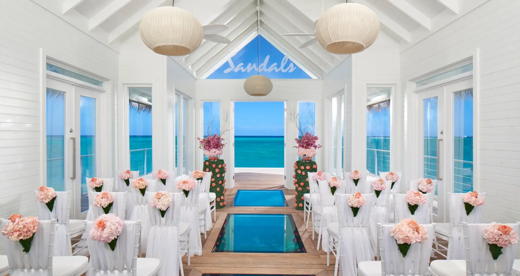 Overwater chapel wedding ceremony setup with glass floor panels at Sandals Montego Bay, Montego Bay