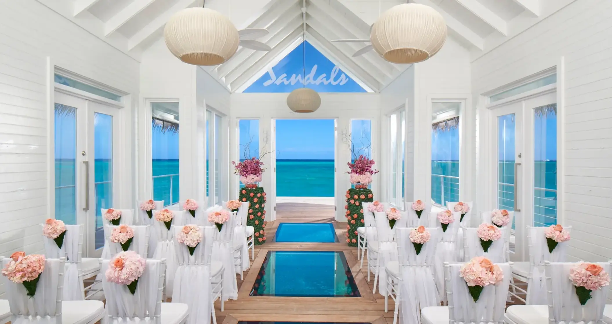 Overwater chapel wedding ceremony setup with glass floor panels at Sandals Montego Bay, Montego Bay