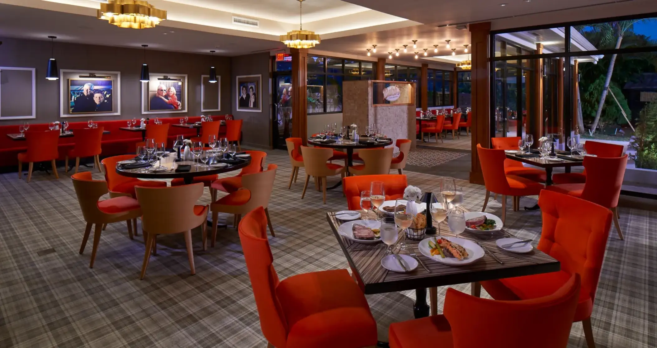 Indoor restaurant with red and tan chairs at Sandals Montego Bay, Montego Bay