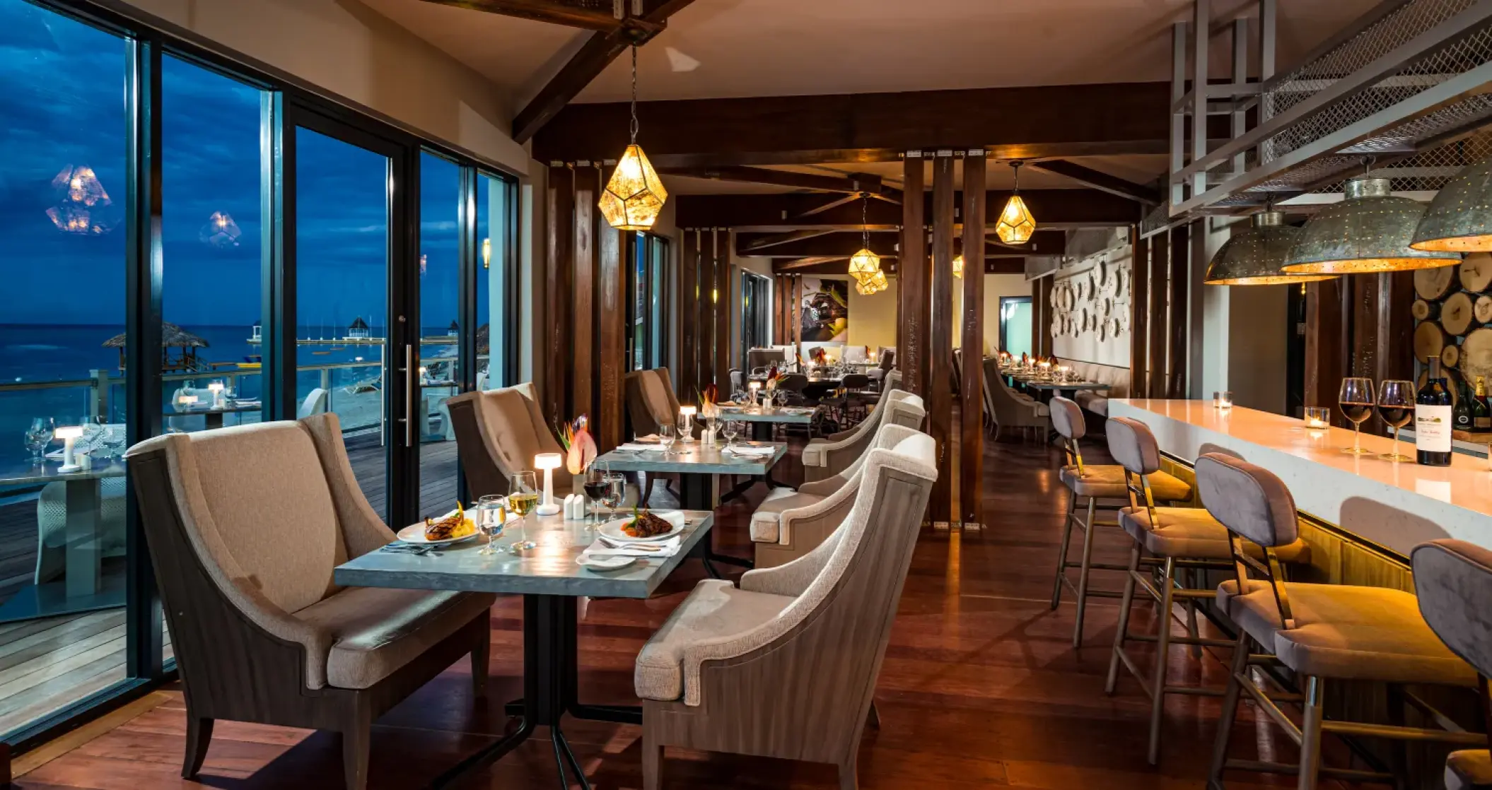 Indoor restaurant and bar with ocean views at Sandals Montego Bay