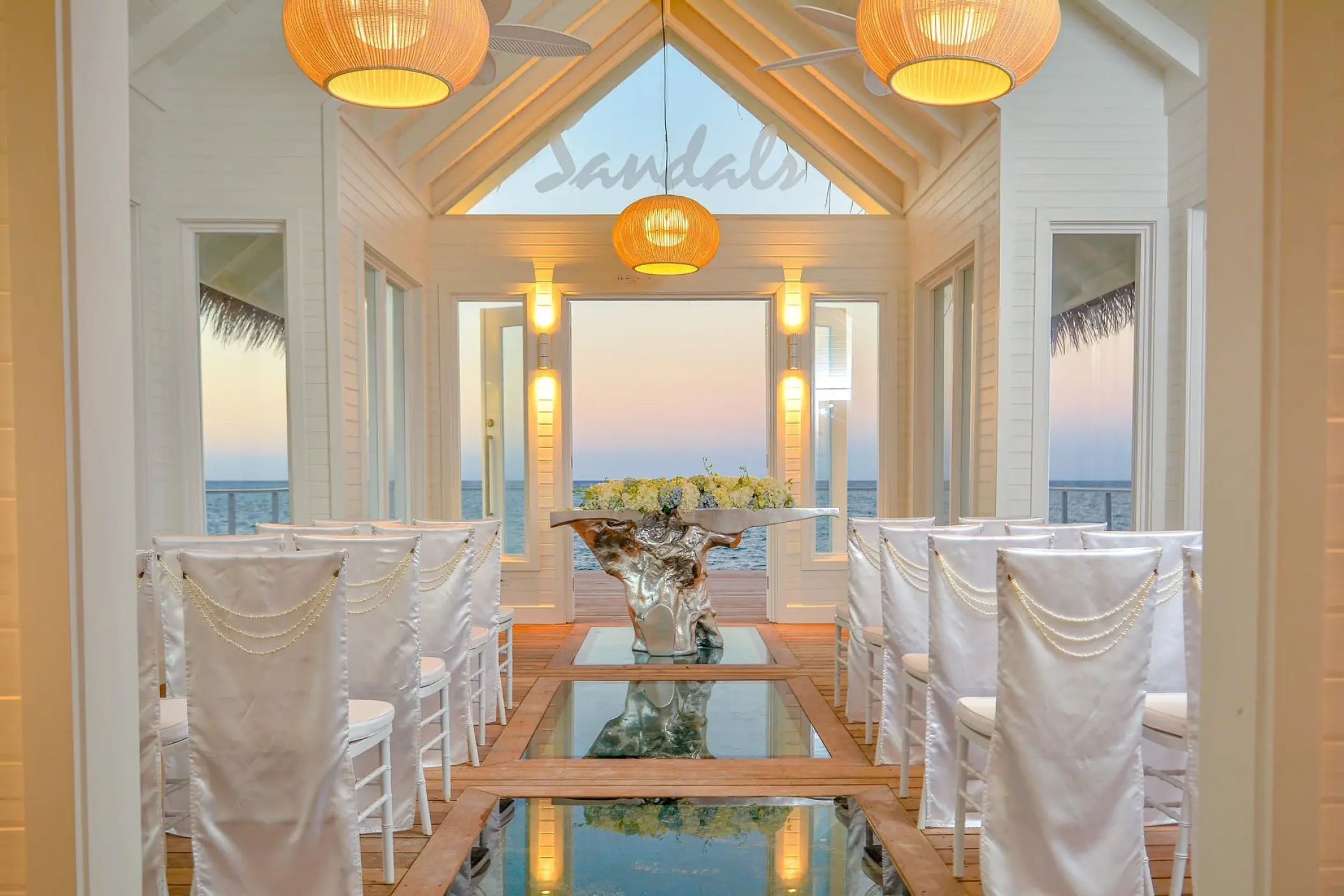 Over-the-water wedding chapel interior with glass floor panels at Sandals Montego Bay