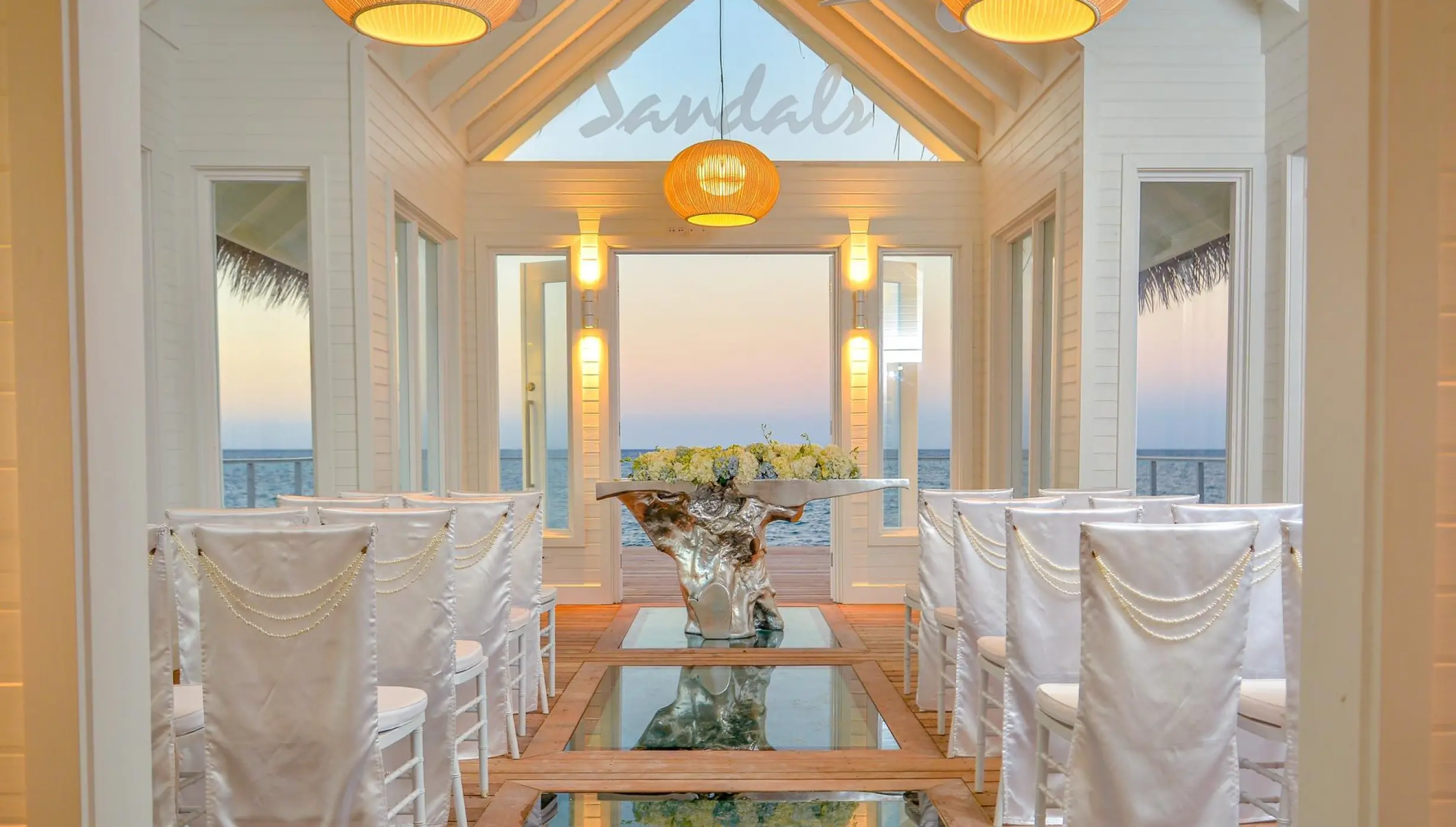 Over-the-water wedding chapel interior with glass floor panels at Sandals Montego Bay