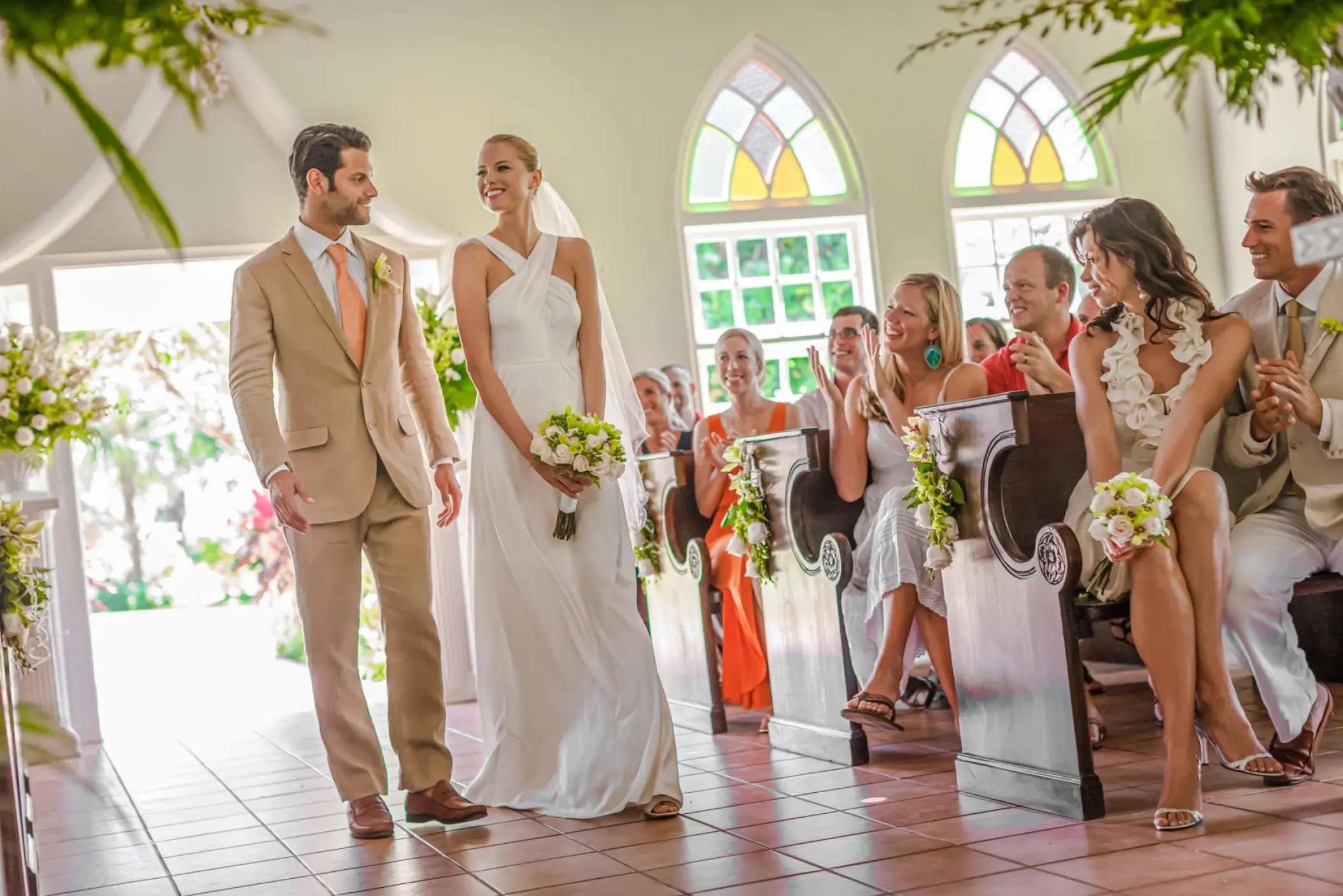 Bride and groom walking down the aisle after a chapel ceremony at Sandals Montego Bay, Jamaica