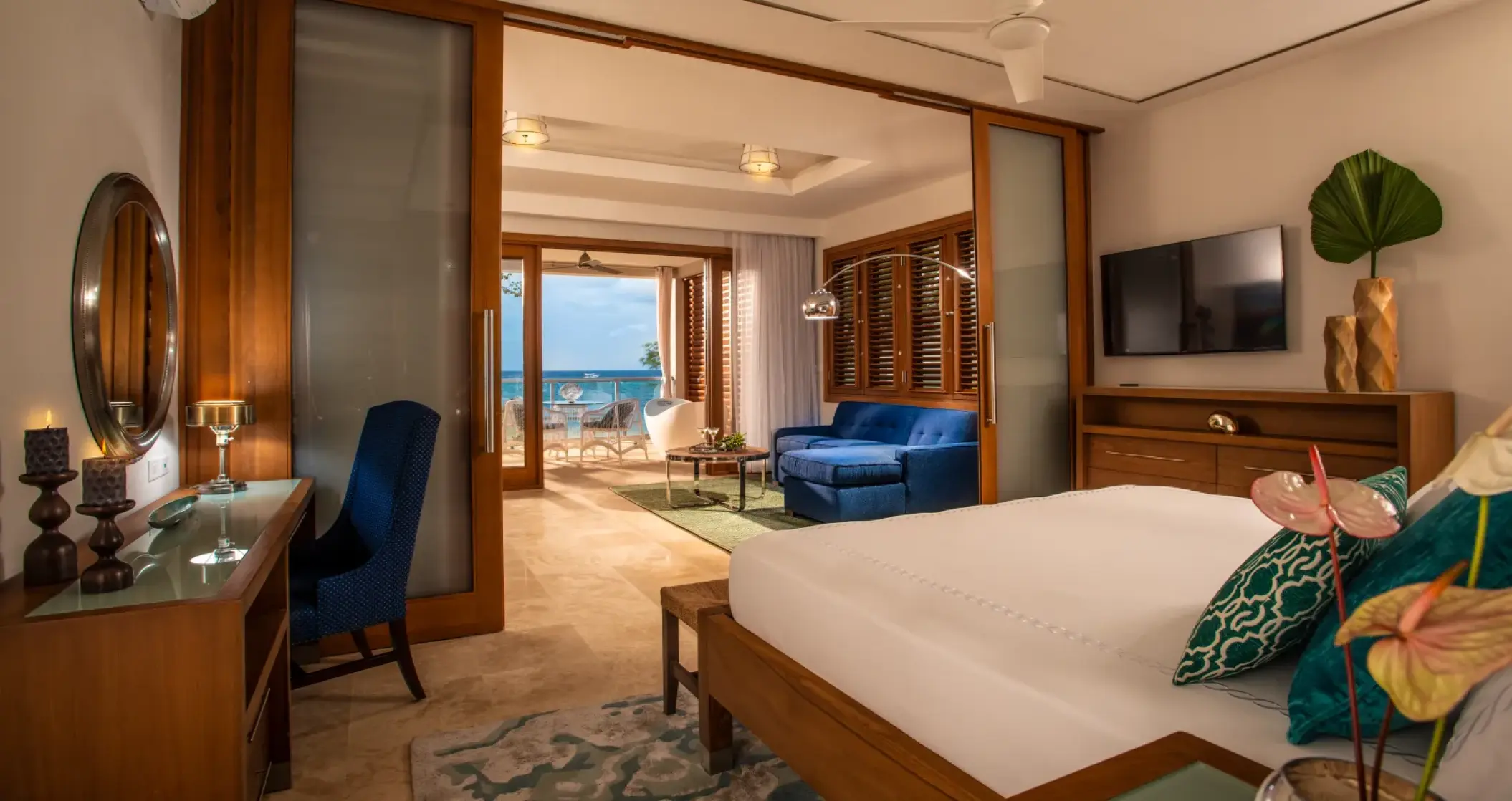 Modern oceanfront suite with a separate lounge and balcony at Sandals Montego Bay