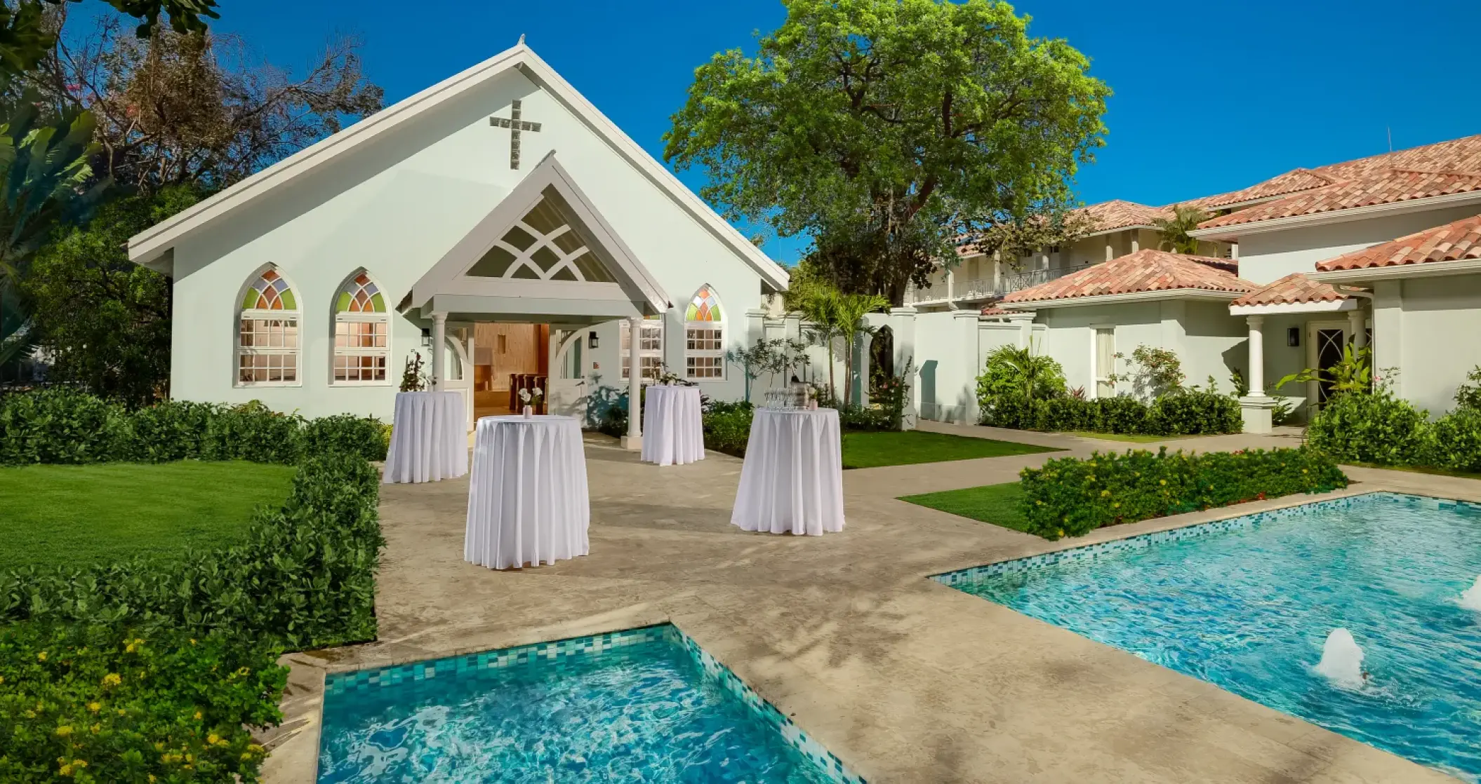 White wedding chapel and cocktail tables at Sandals Montego Bay, Jamaica