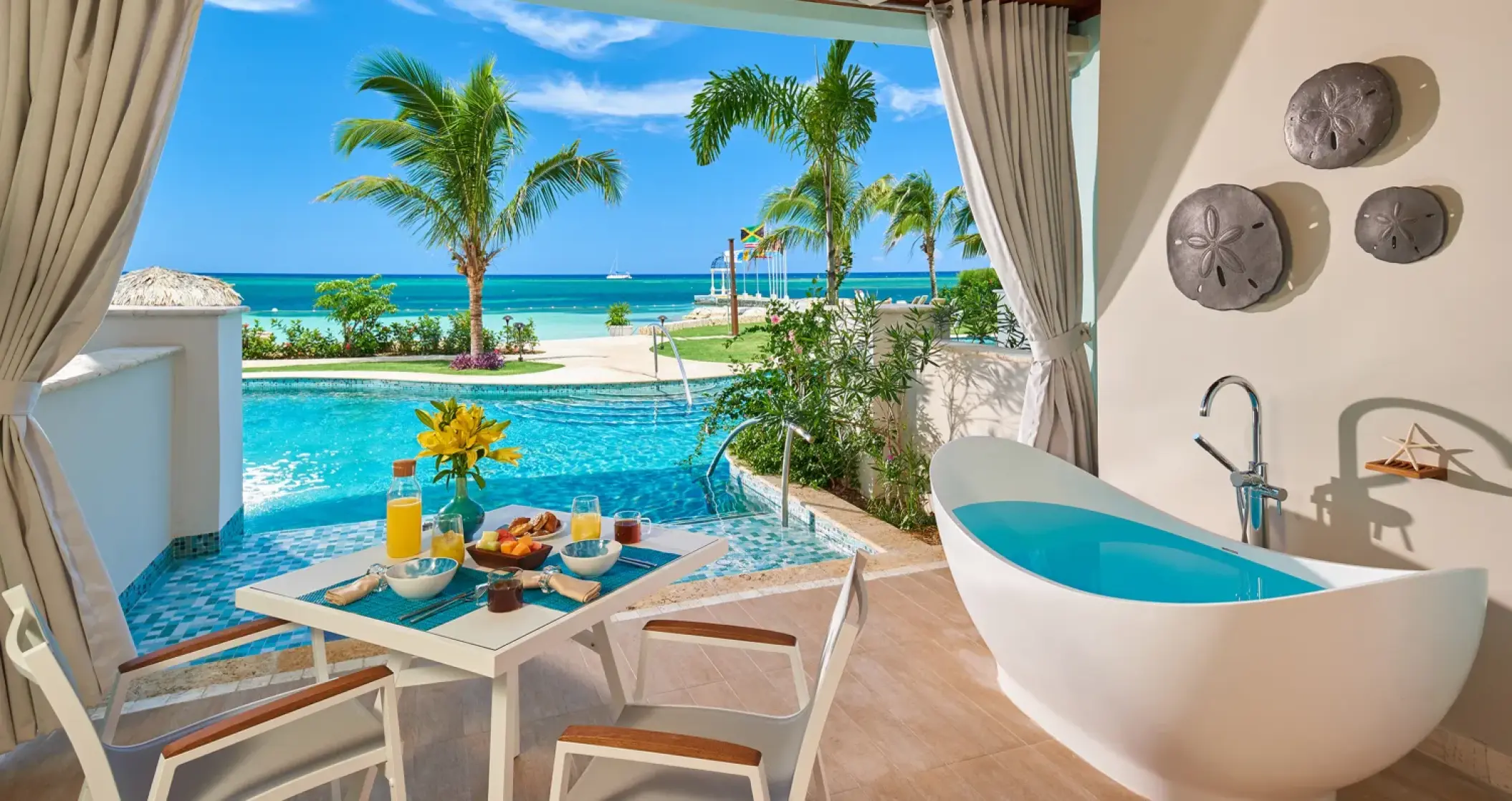 Swim-up suite with a soaking tub and breakfast table at Sandals Montego Bay