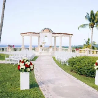 European wedding garden ceremony setup with gazebo and white chairs at Sandals Ochi, Ocho Rios