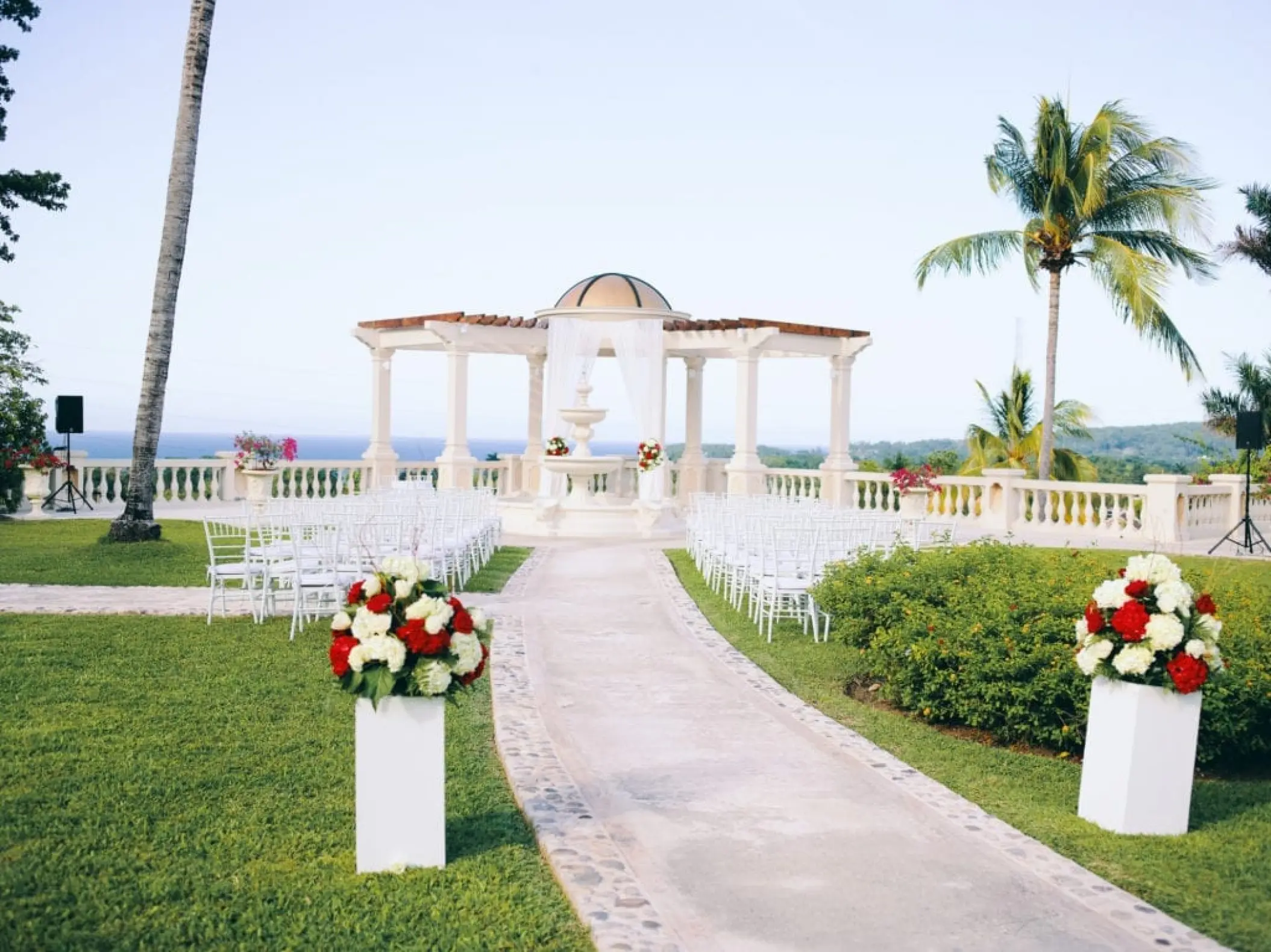 European wedding garden ceremony setup with gazebo and white chairs at Sandals Ochi, Ocho Rios