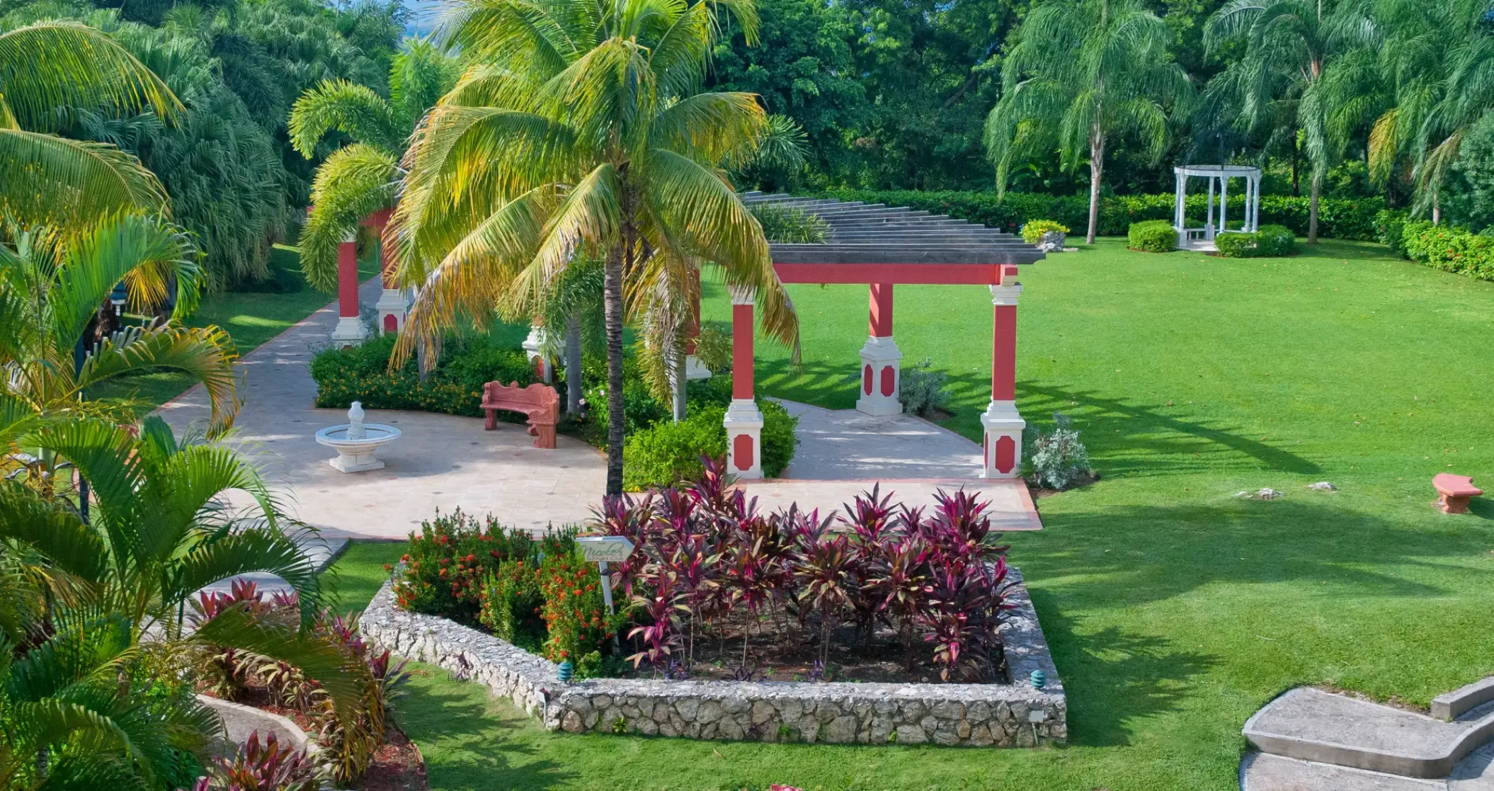 European Wedding Garden with a red gazebo and manicured lawn at Sandals Ochi, Ocho Rios