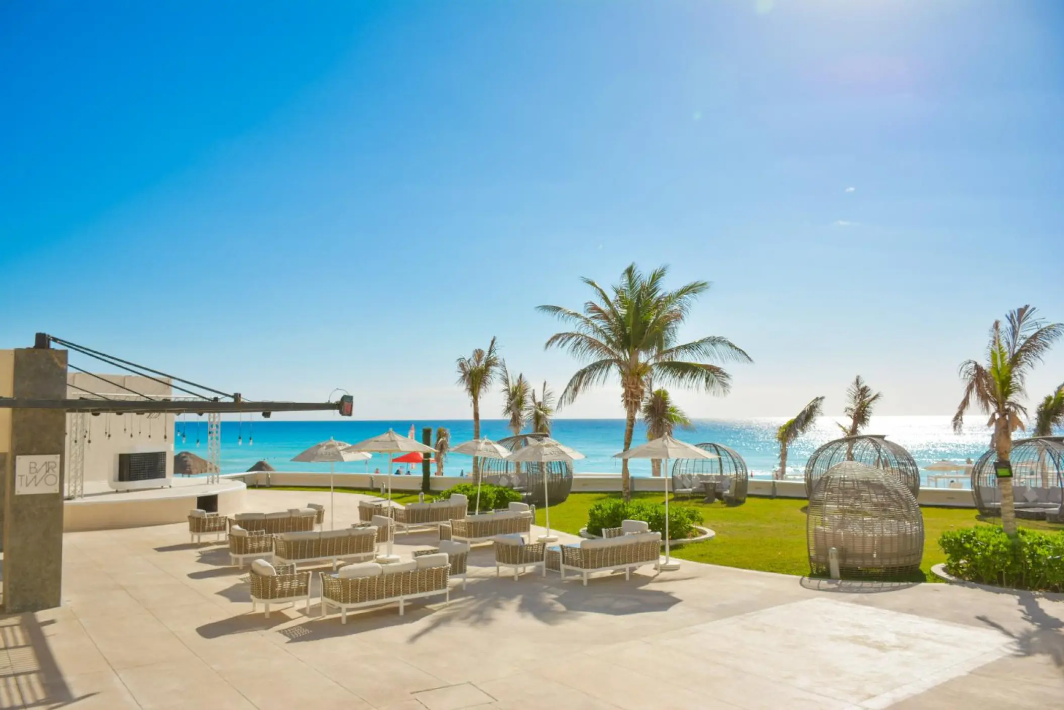 Outdoor lounge and bar terrace overlooking the ocean at Sandos Cancun, Cancun
