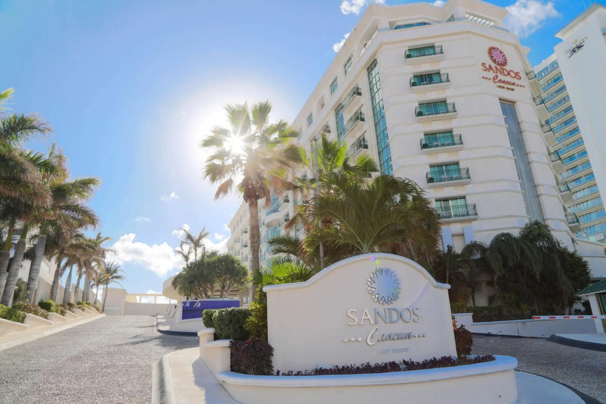 Sandos Cancun main entrance and resort exterior with palm trees, Cancun