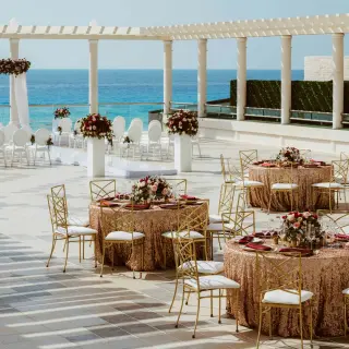 Rooftop wedding ceremony and reception setup overlooking the ocean at Sandos Cancun, Cancun