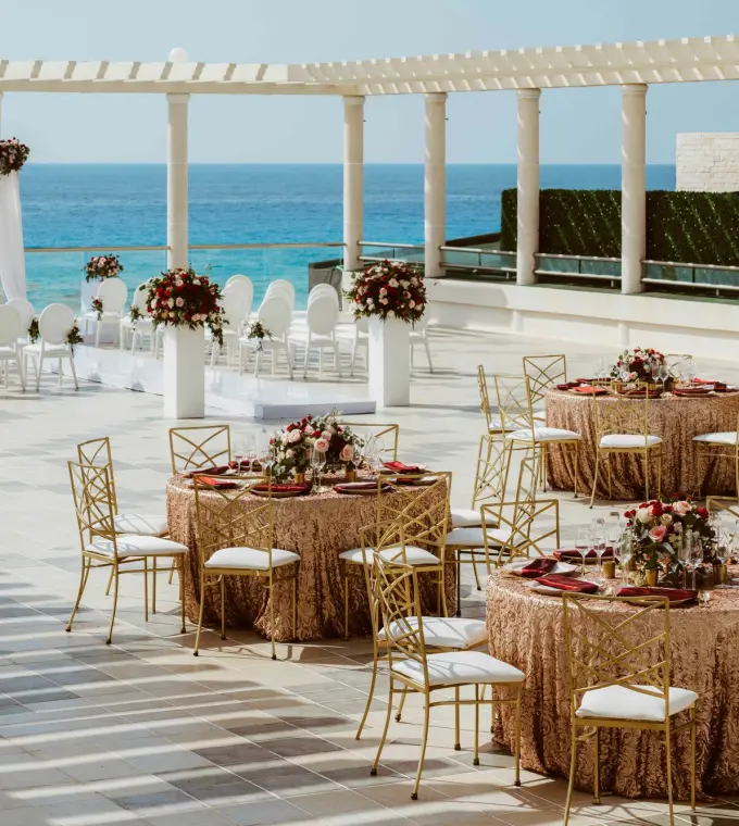 Rooftop wedding ceremony and reception setup overlooking the ocean at Sandos Cancun, Cancun