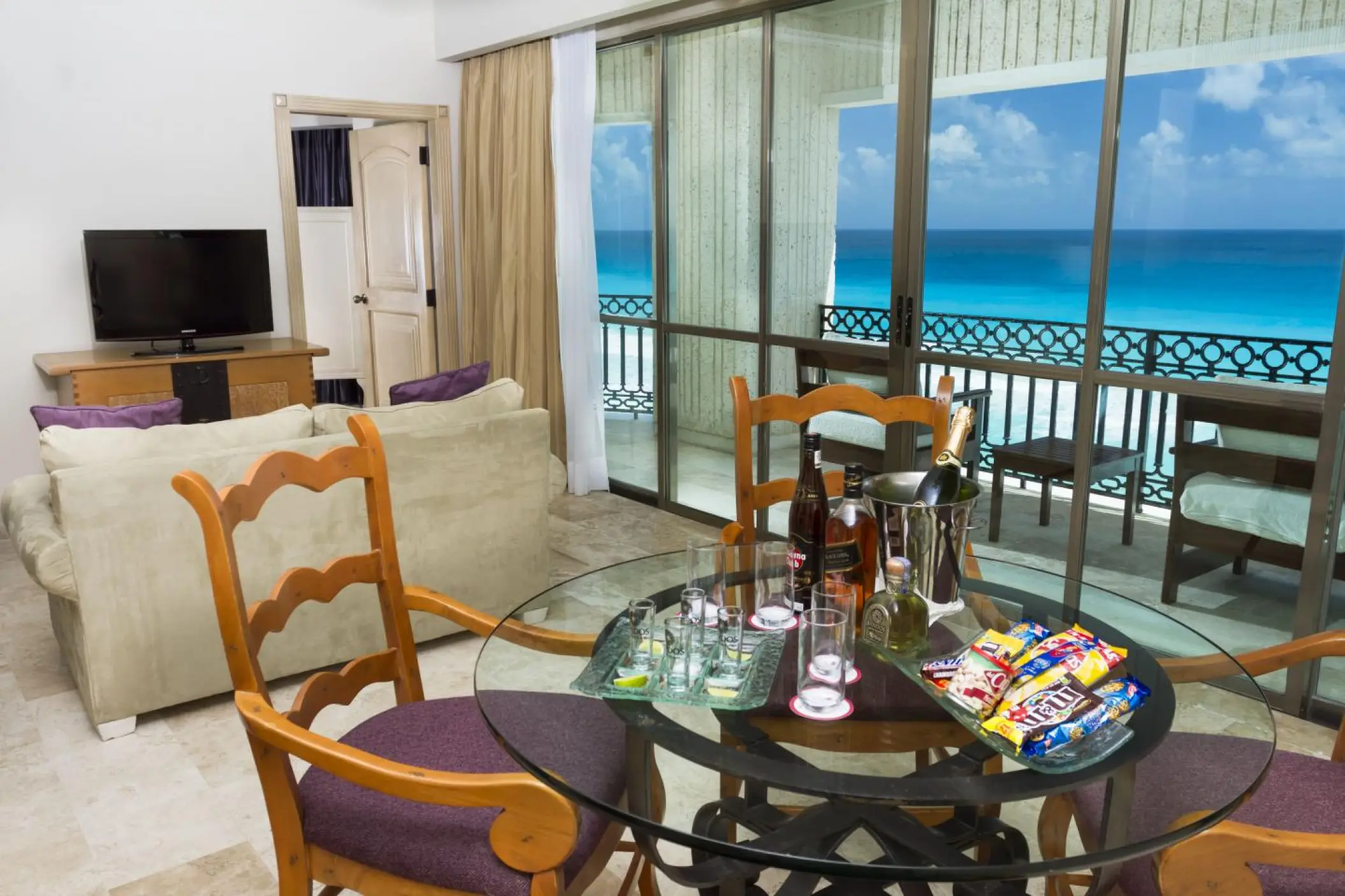 Sandos Cancun suite living room overlooking the turquoise ocean, Cancun