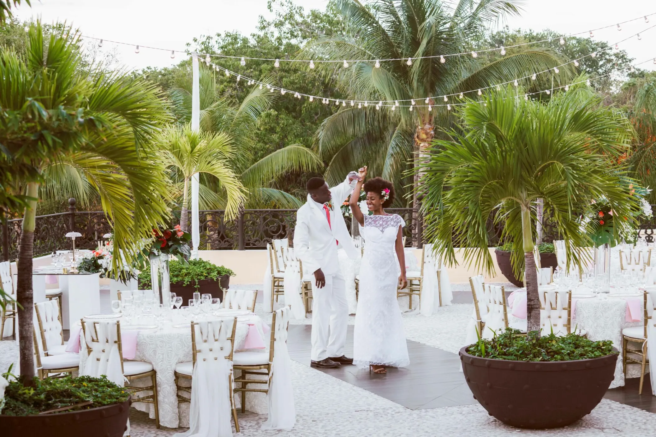 Bride and groom dancing at an outdoor terrace wedding reception at Sandos Playacar, Playa Del Carmen