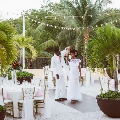 Bride and groom dancing at an outdoor terrace wedding reception at Sandos Playacar, Playa Del Carmen