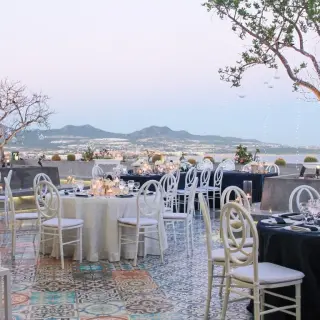 Terrace wedding reception with white and navy tables at Sandos Finisterra, Cabo San Lucas
