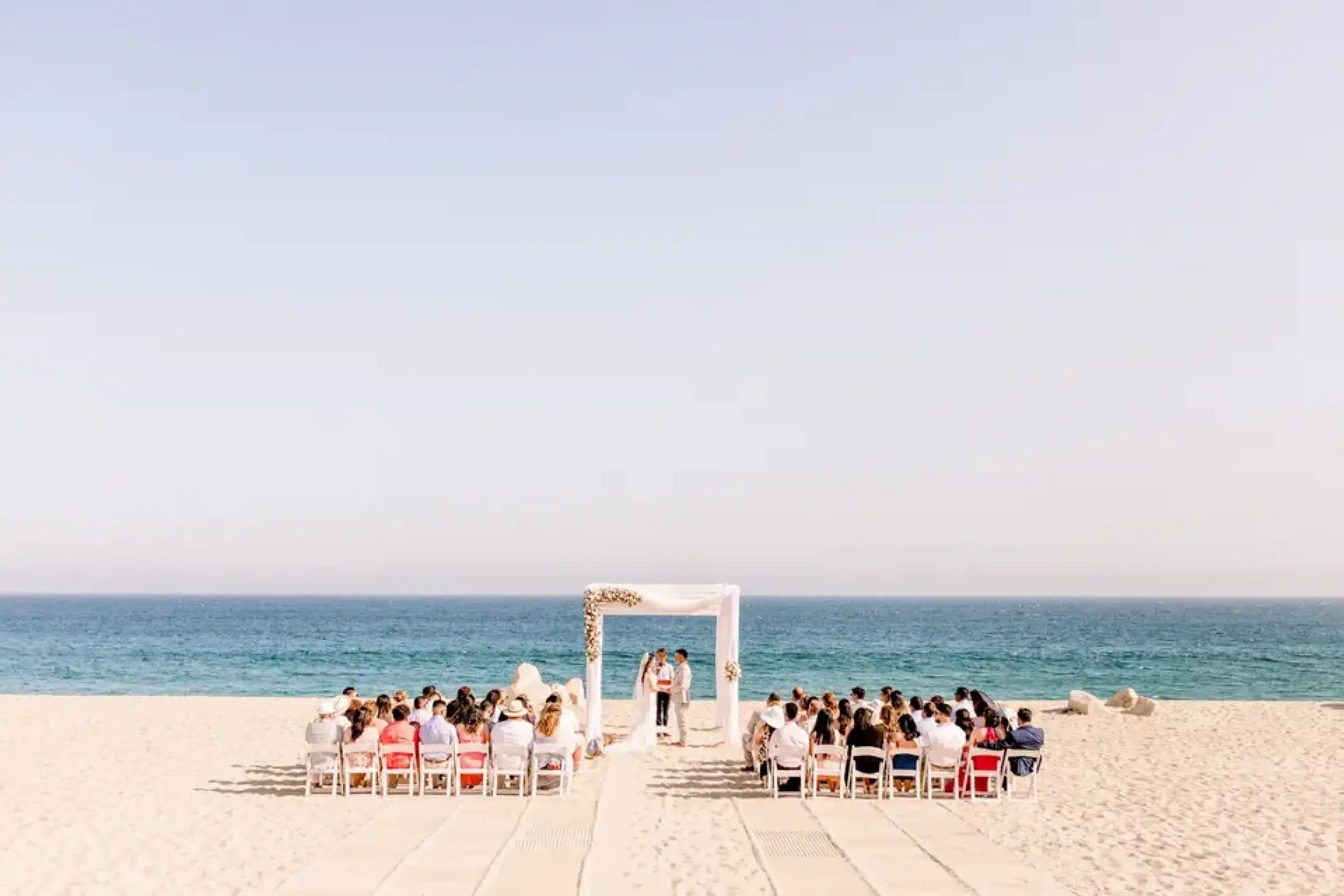 Beachfront wedding ceremony on the white sand at Sandos Finisterra, Cabo San Lucas