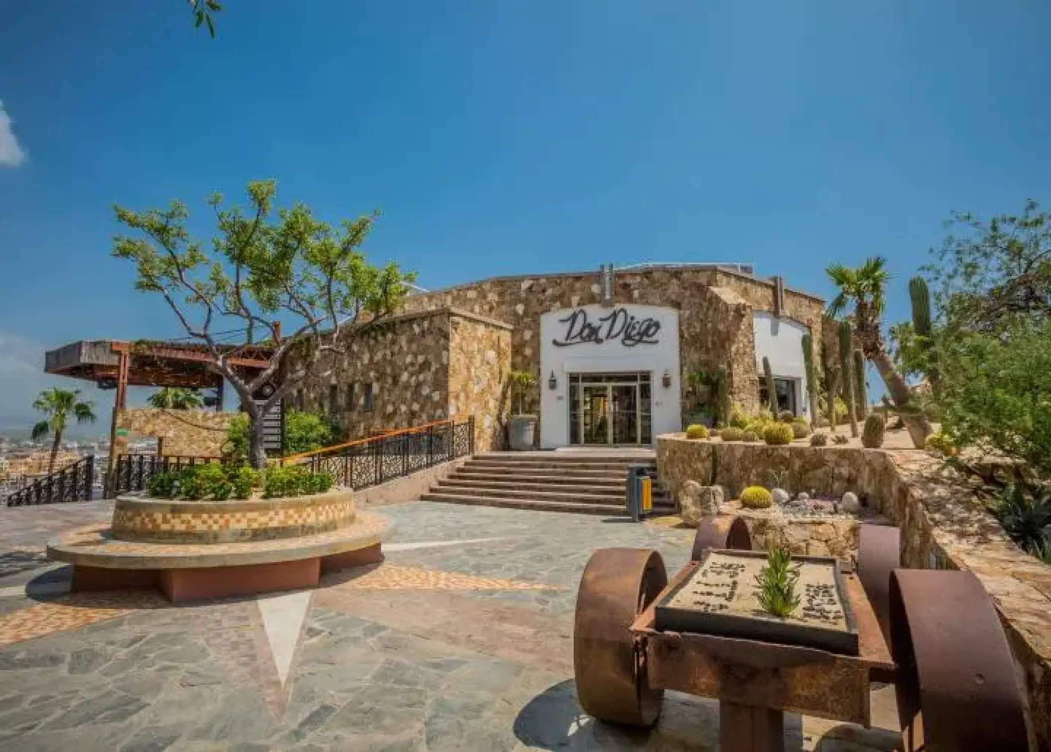 Don Diego restaurant exterior with stone walls and desert landscaping at Sandos Finisterra, Cabo San Lucas