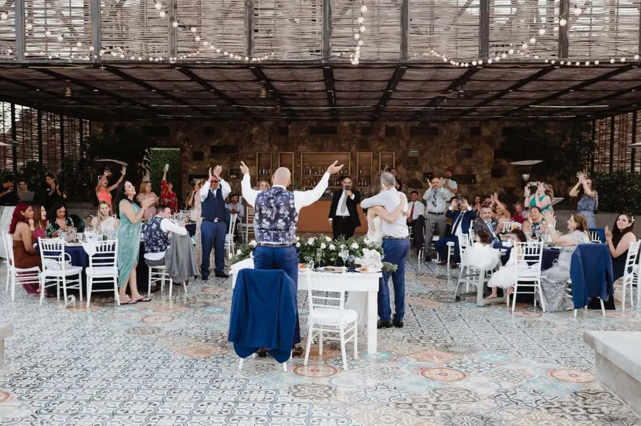 Wedding reception under a wood slat roof at Sandos Finisterra, Cabo San Lucas