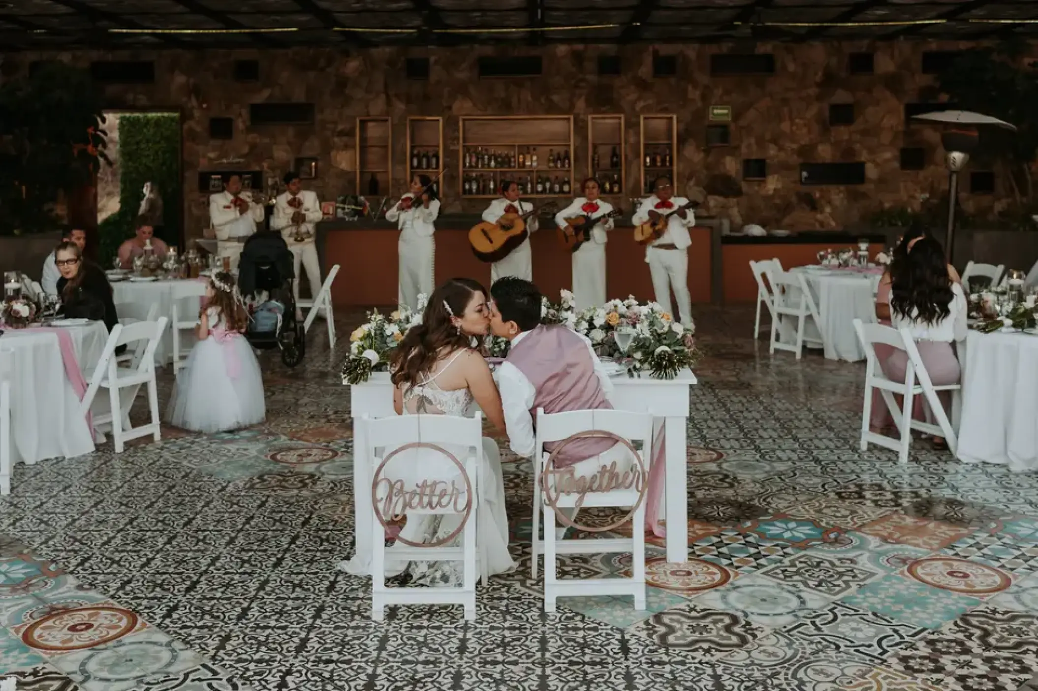Newlywed couple kissing at their reception at Sandos Finisterra, Cabo San Lucas