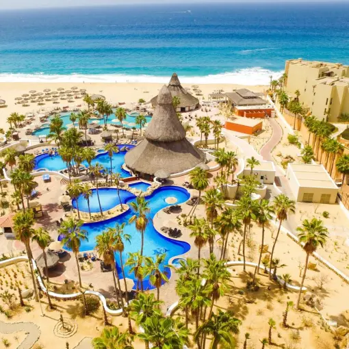Aerial view of swimming pools and palm trees at Sandos Finisterra, Cabo San Lucas