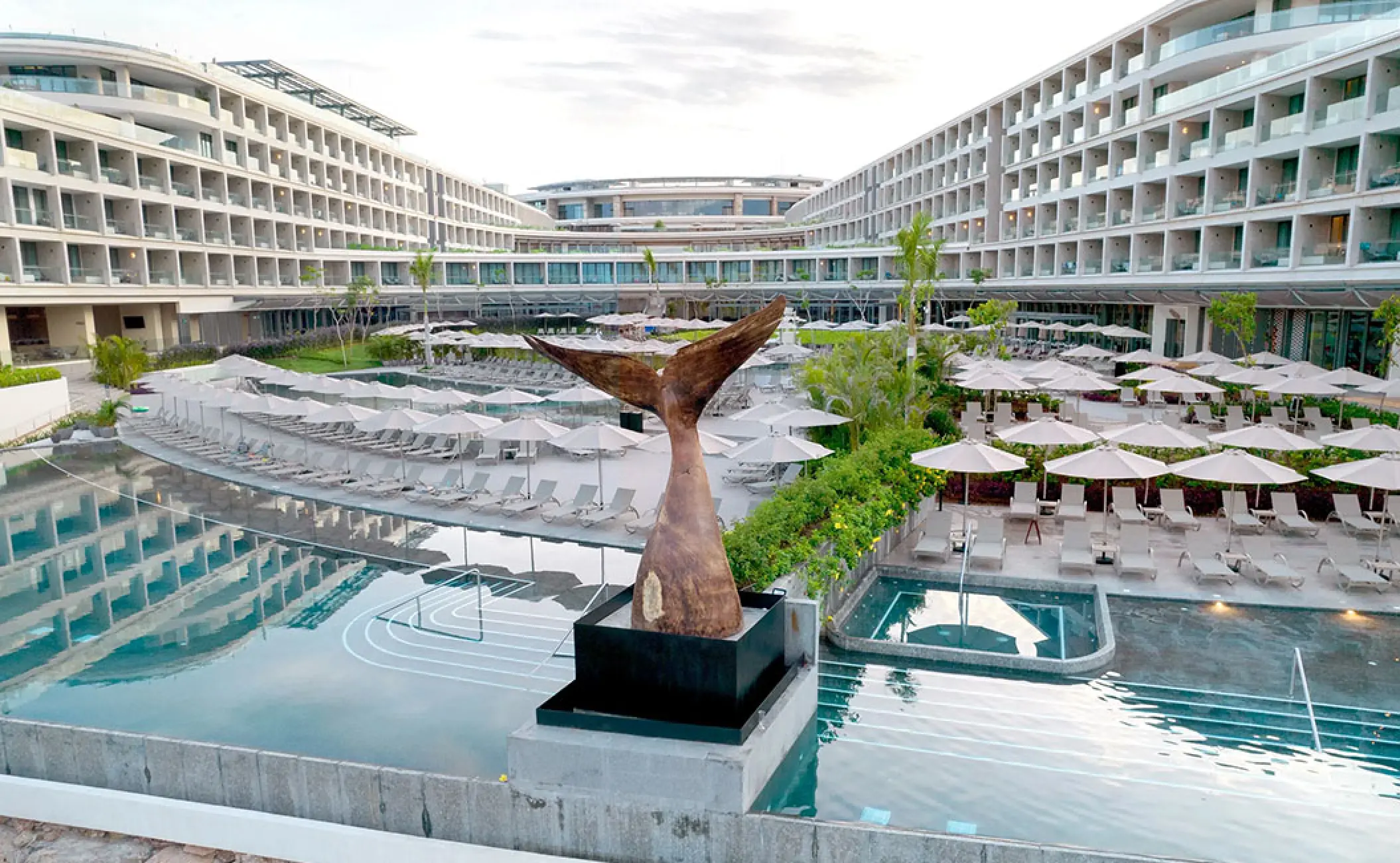Whale tail sculpture and courtyard swimming pools at Secrets Bahia Mita, Puerto Vallarta