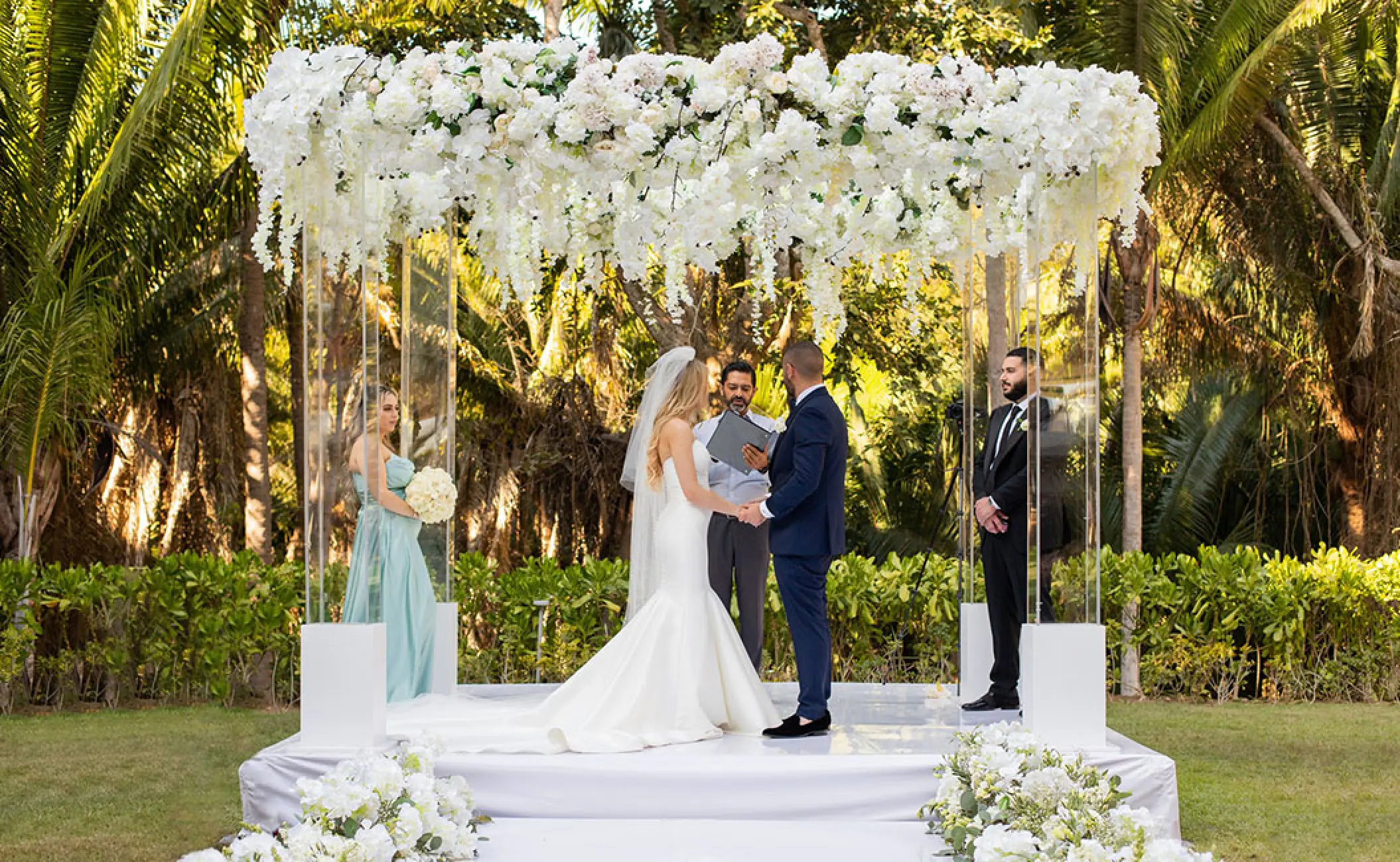 Wedding ceremony under a white flower canopy at Secrets Bahia Mita, Puerto Vallarta