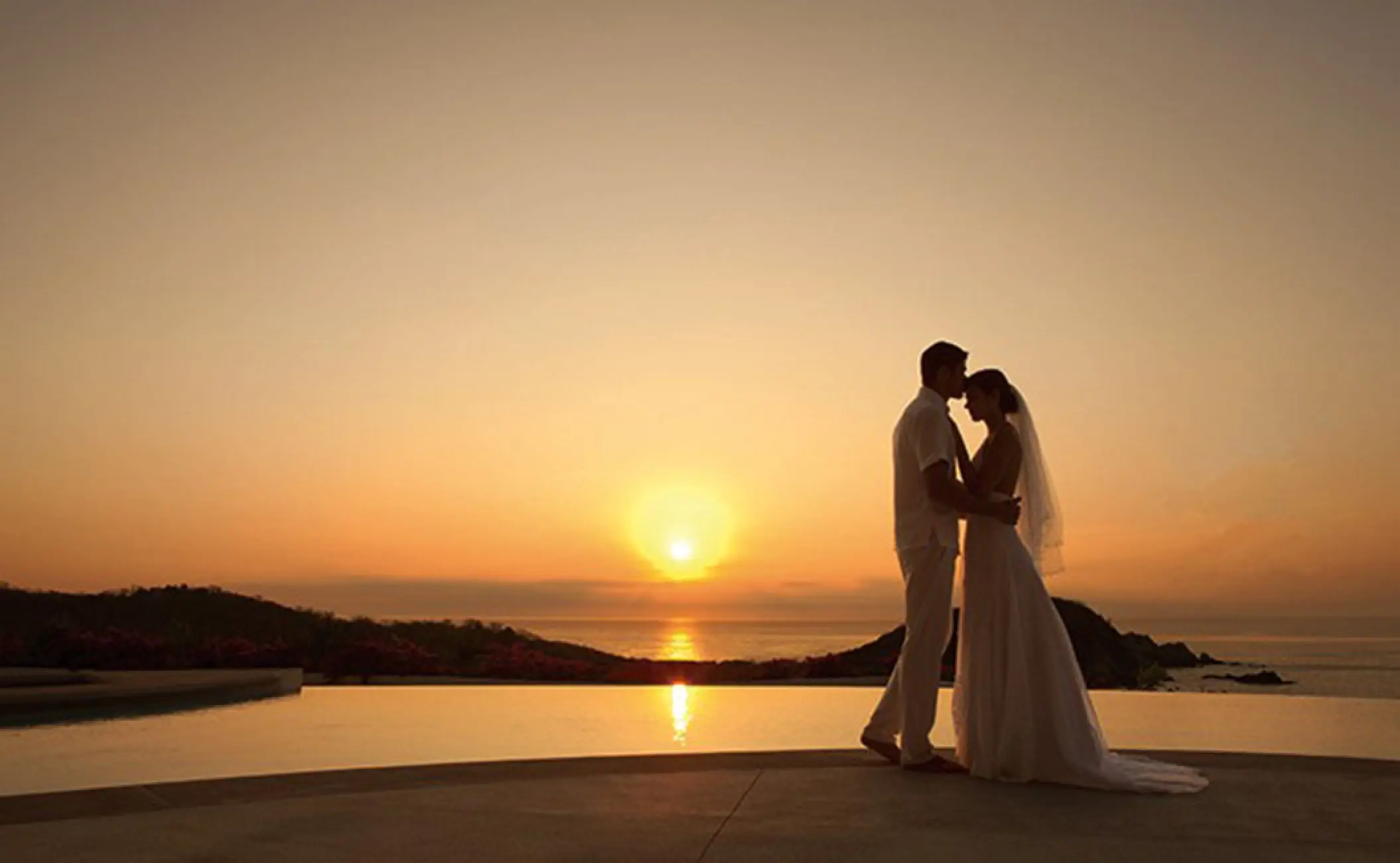 Silhouette of a bride and groom at sunset at Secrets Bahia Mita, Puerto Vallarta