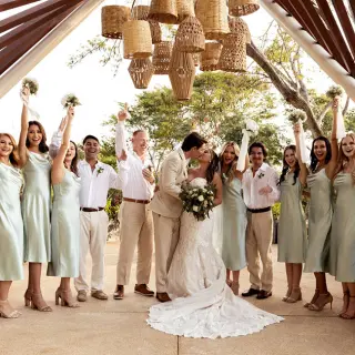 Bride and groom kissing with their wedding party at Secrets Bahia Mita, Puerto Vallarta