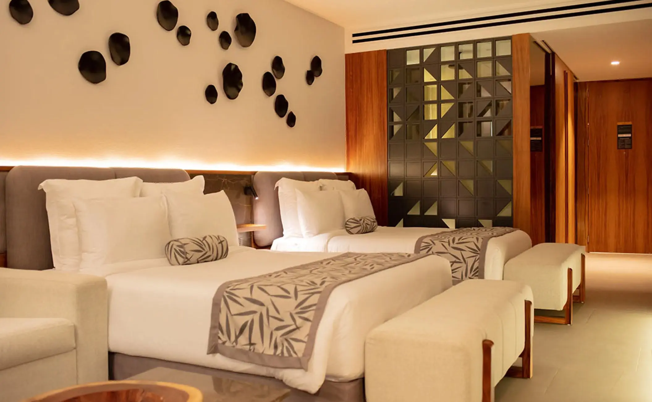 Junior Suite with two queen beds and modern wood accents at Secrets Bahia Mita, Puerto Vallarta