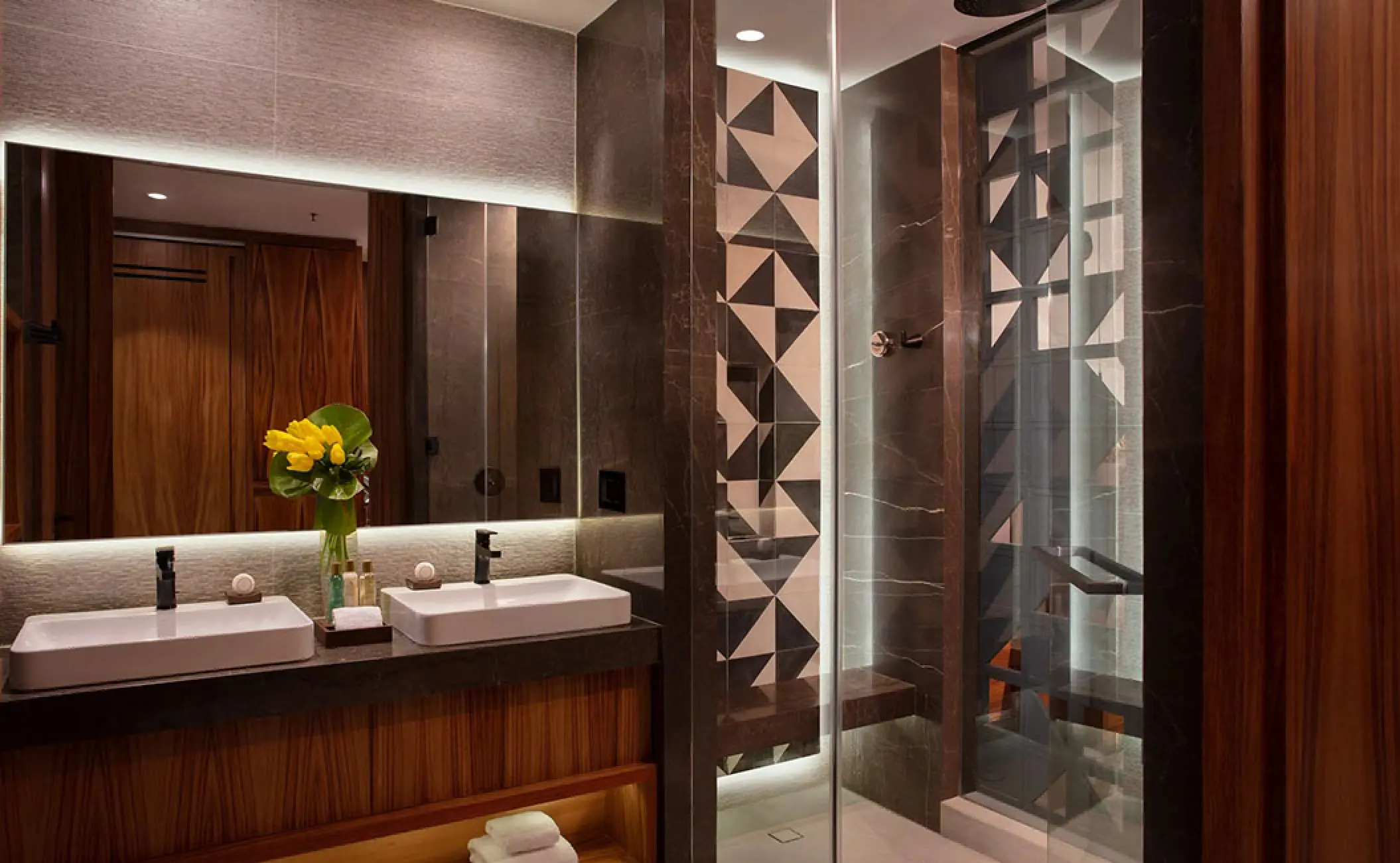 Modern bathroom with double sinks and glass walk-in shower at Secrets Bahia Mita, Puerto Vallarta