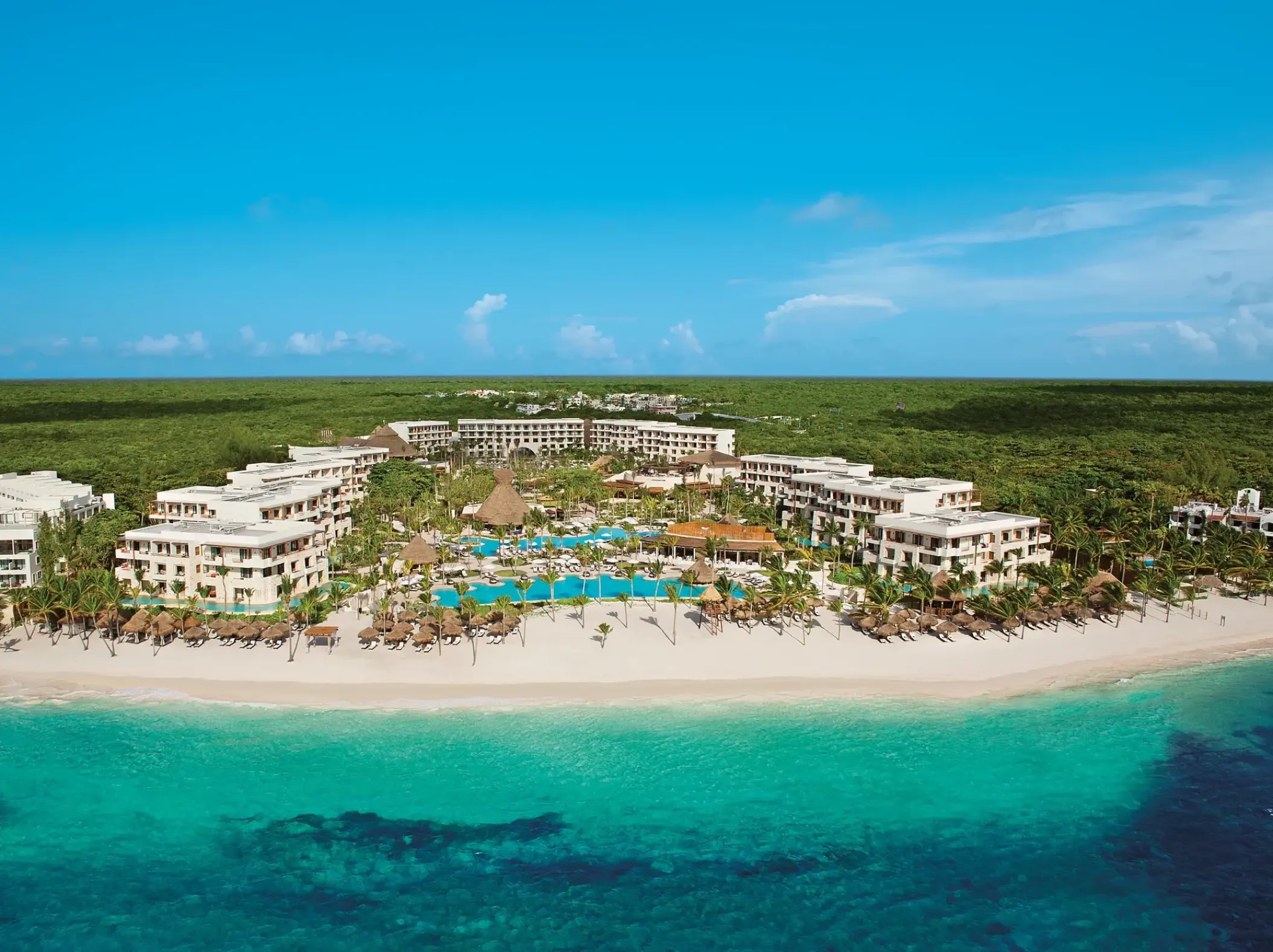 Aerial view of Secrets Akumal buildings and pools along the white sand beach, Riviera Maya