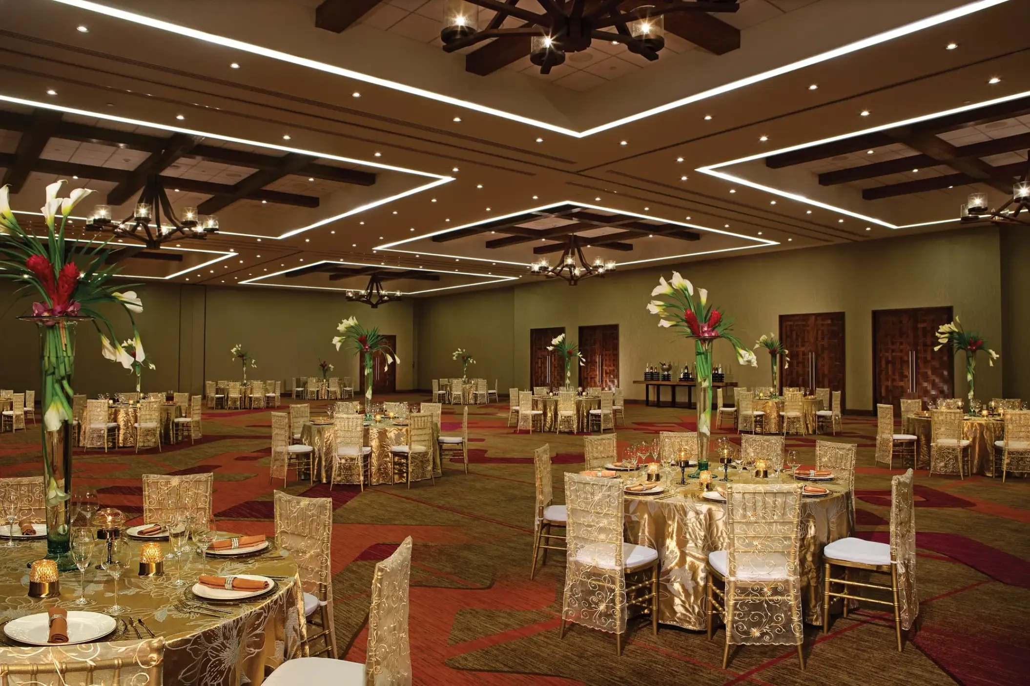 Ballroom wedding reception setup with gold linens at Secrets Akumal, Riviera Maya