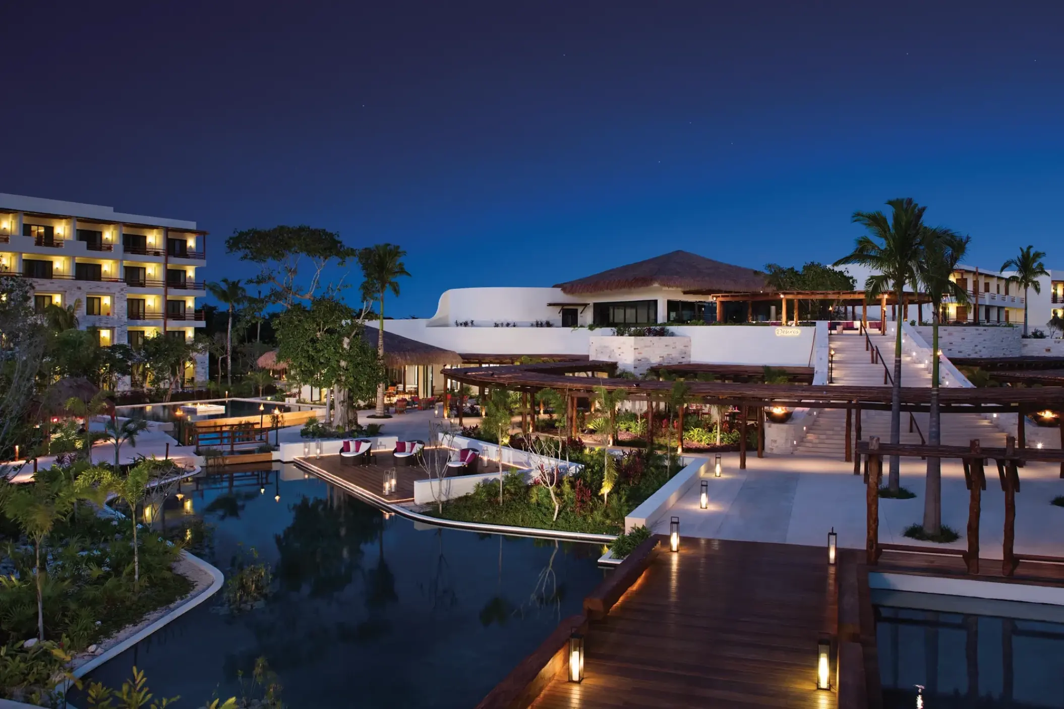 Secrets Akumal grounds and buildings illuminated at night, Riviera Maya
