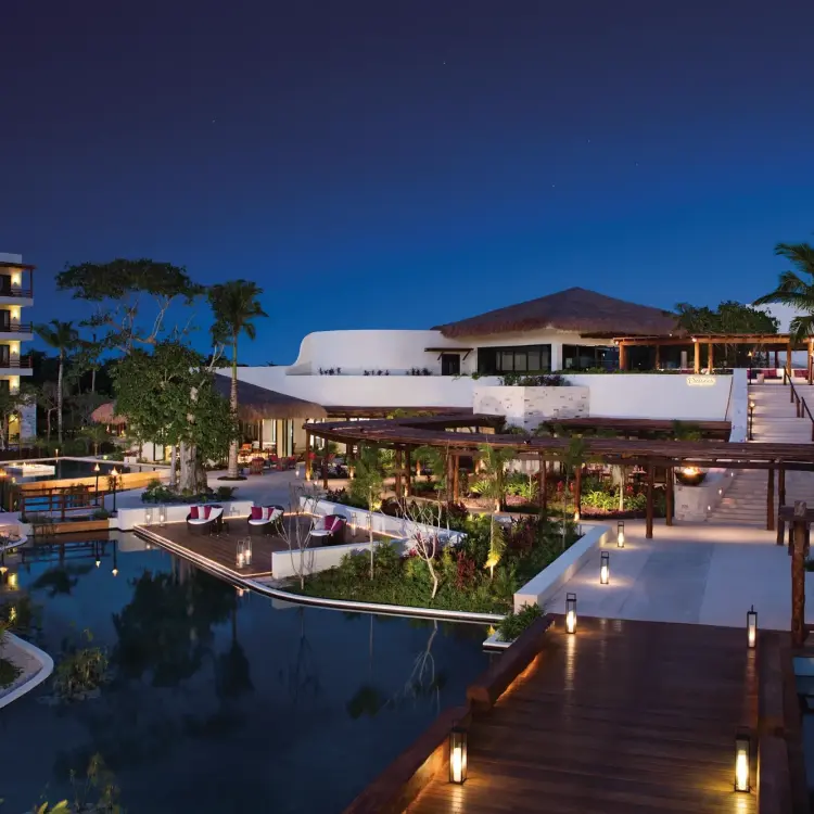 Secrets Akumal grounds and buildings illuminated at night, Riviera Maya