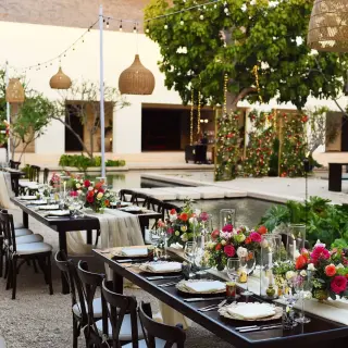 Central Plaza wedding reception with floral centerpieces and hanging lanterns at Secrets Akumal, Riviera Maya
