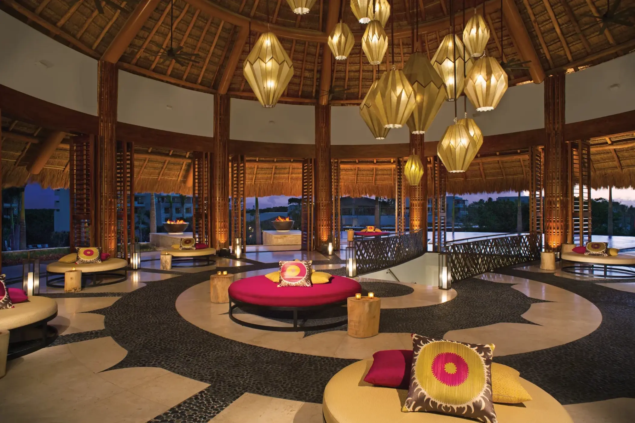 Circular lobby lounge with hanging lanterns and palapa roof at Secrets Akumal, Riviera Maya