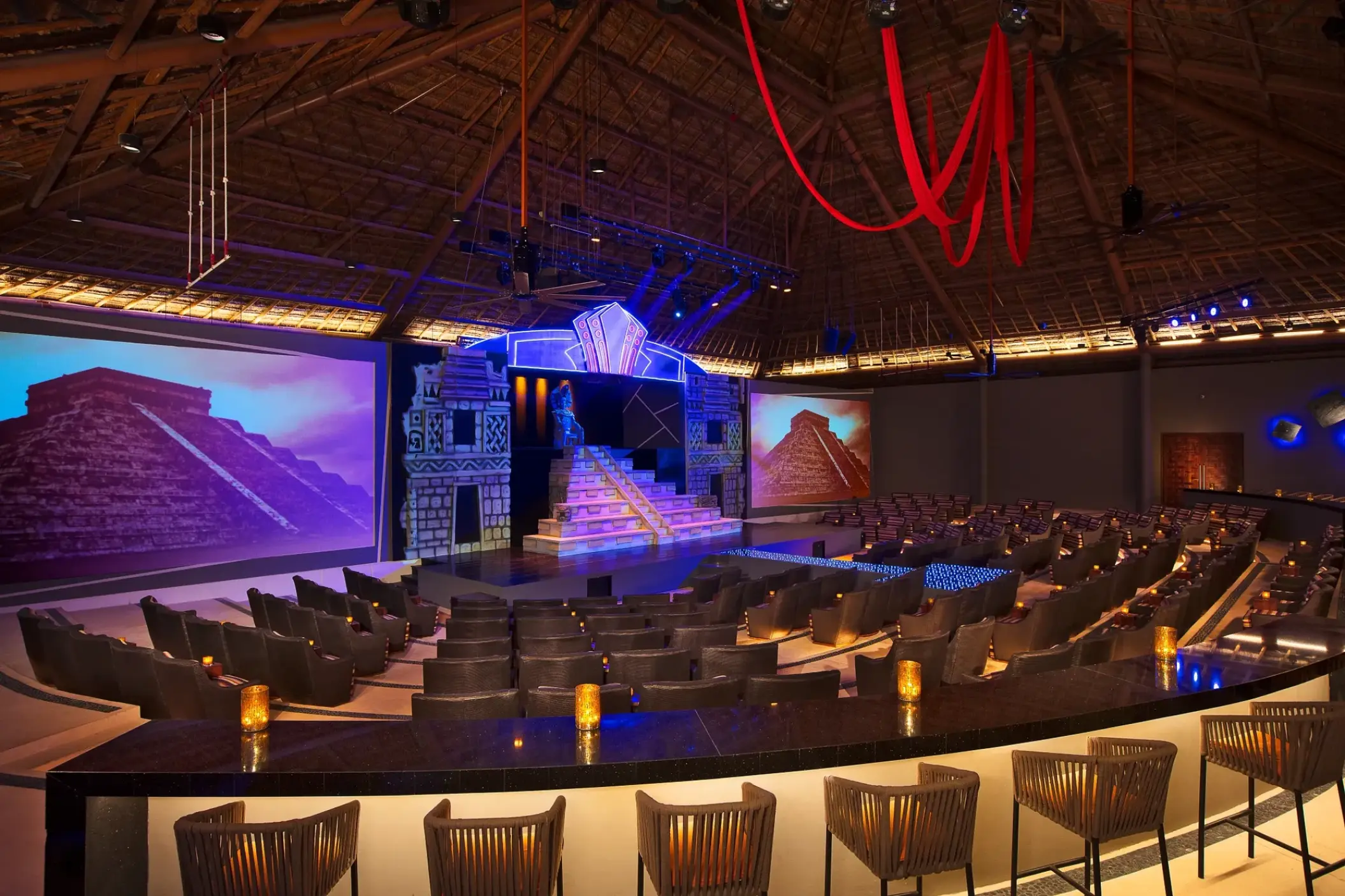 Indoor theater with tiered seating and stage at Secrets Akumal, Riviera Maya