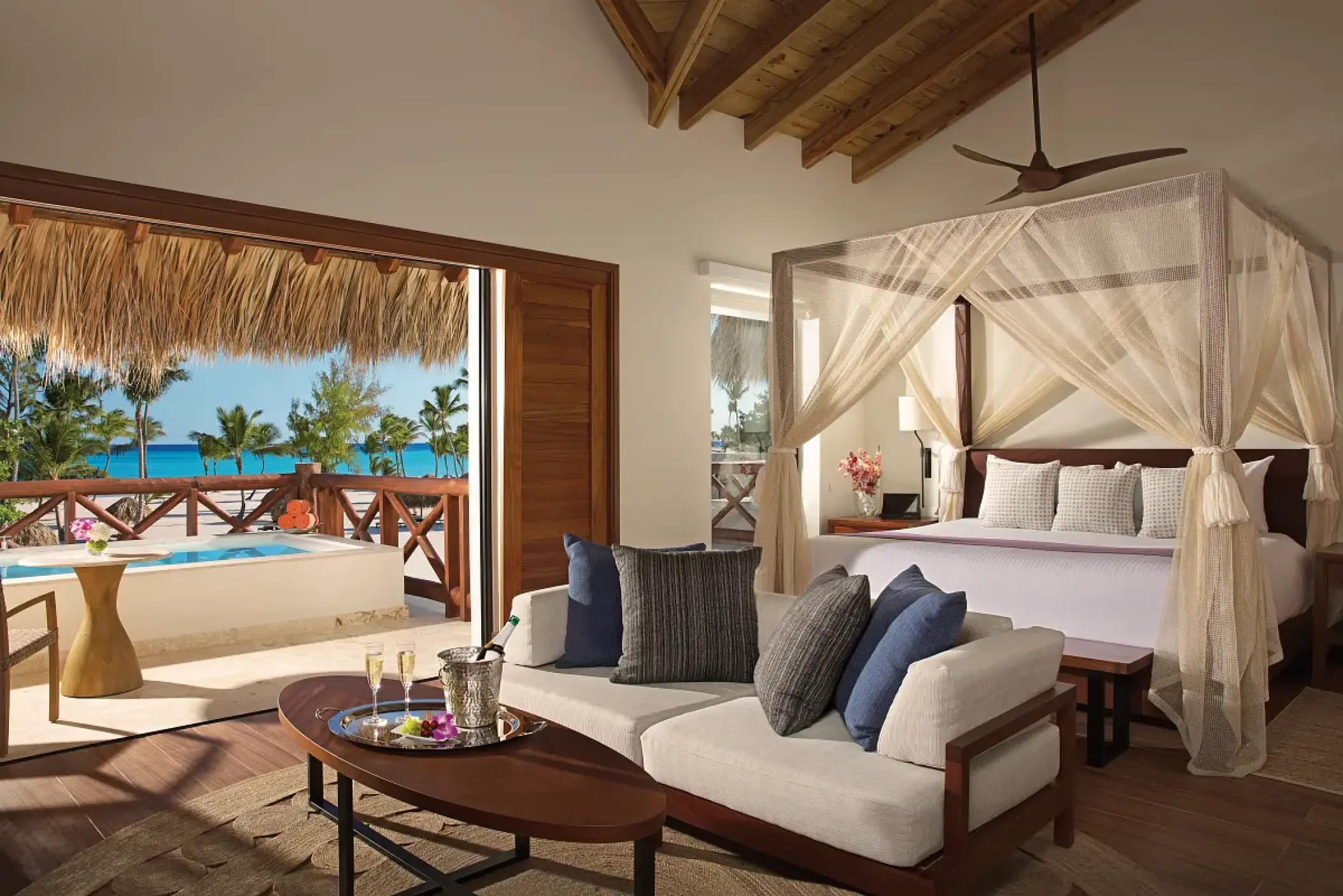 Bungalow master suite with a canopy bed and private terrace at Secrets Cap Cana, Punta Cana