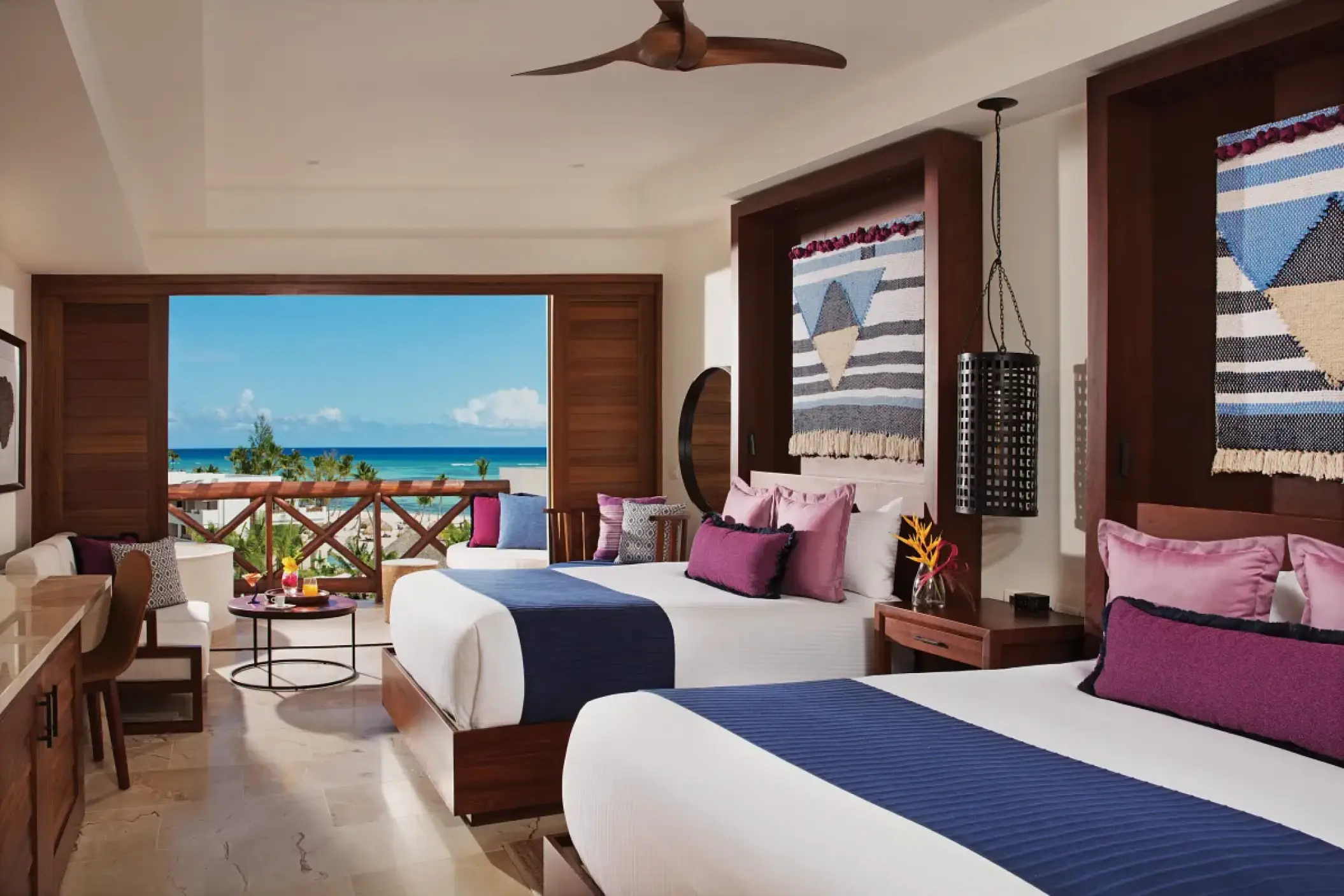 Junior suite with two double beds and ocean view balcony at Secrets Cap Cana, Punta Cana