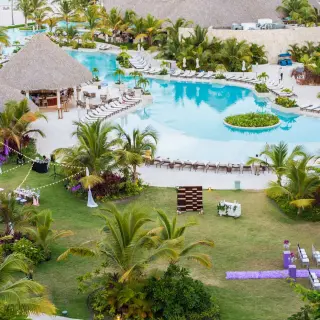 Aerial view of a garden wedding reception and swimming pool at Secrets Cap Cana, Punta Cana