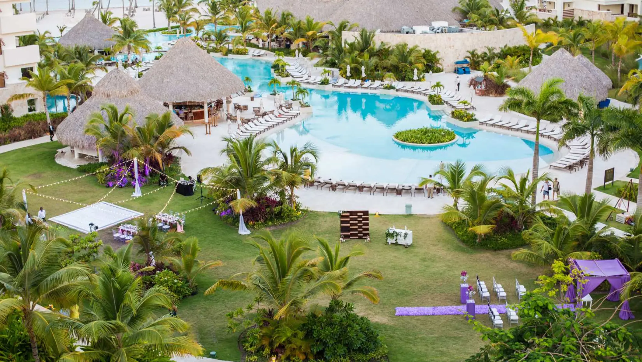 Aerial view of a garden wedding reception and swimming pool at Secrets Cap Cana, Punta Cana