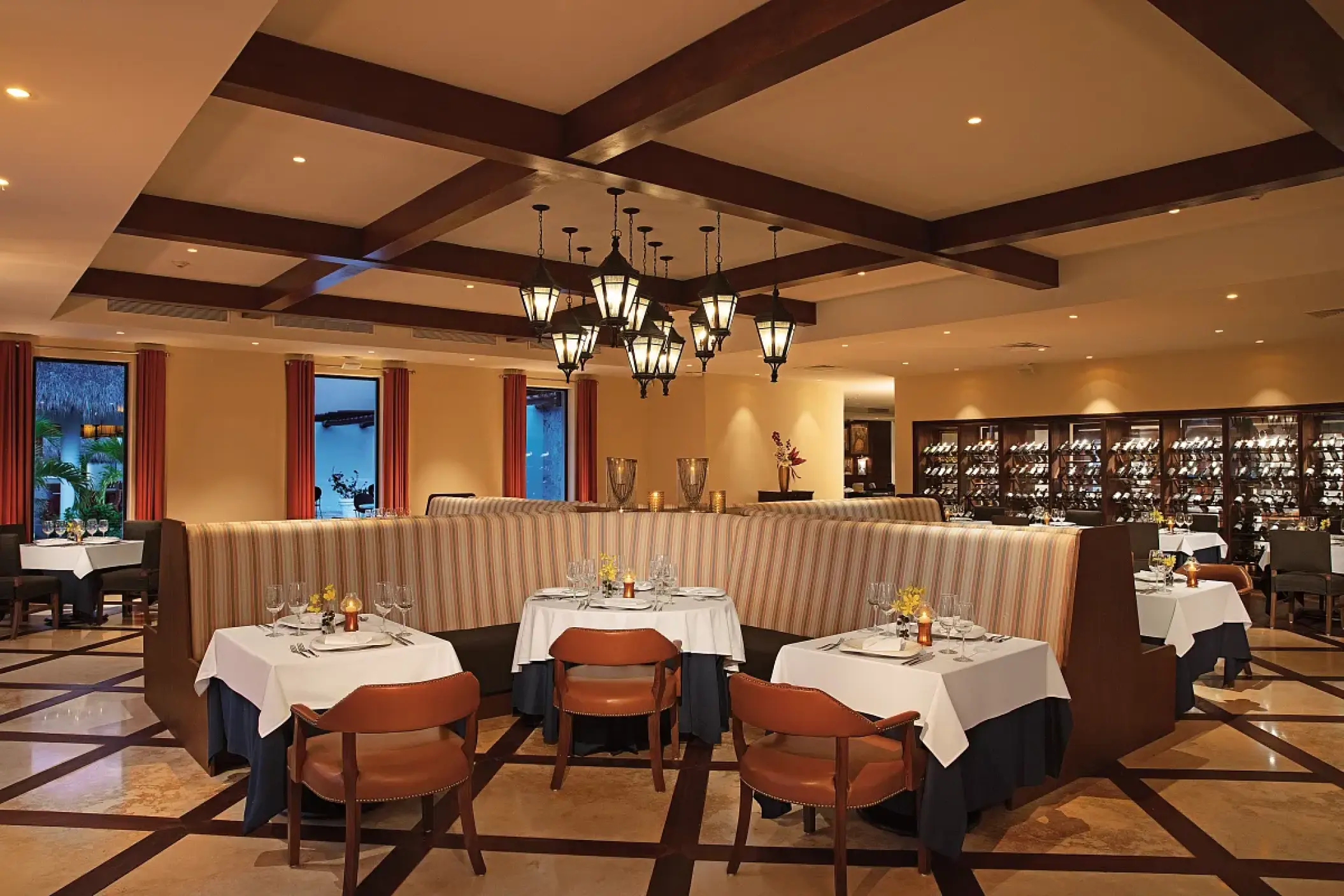Portofino restaurant with candlelit tables and wood-beamed ceilings at Secrets Cap Cana, Punta Cana